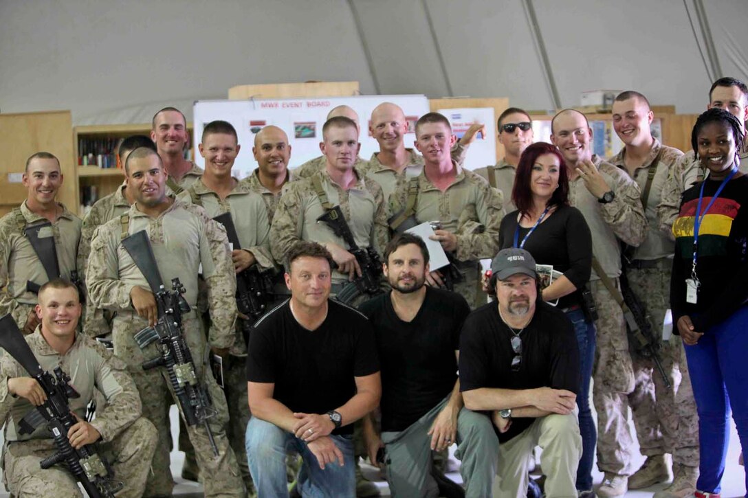 Members of the country music band The Frontmen pose for a picture with Marines of 2nd Battalion, 8th Marine Regiment, Regimental Combat Team 7, and the staff at the Morale, Welfare and Recreation (MWR) center here, May 23, 2013. "We needed this performance just as much as these guys did," said Erick Baker. "We're here for the troops and to say thank you, and the crowd today really picked us up." (U.S. Marine Corps photo by Lance Cpl. Mel Johnson)