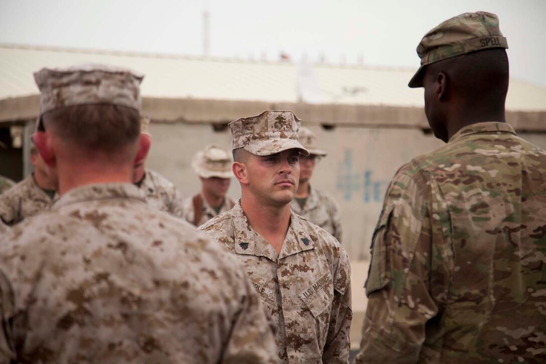 U.S. Marine Corps Sgt. Philip Noble with Headquarters Company, Regimental Combat Team (RCT) 7, is recocnized during an award ceremony on Camp Leatherneck, Afghanistan, May 9, 2013. Noble is deployed to Afghanistan in support of Operation Enduring Freedom. (U.S. Marine Corps photo by Kowshon Ye/Released)