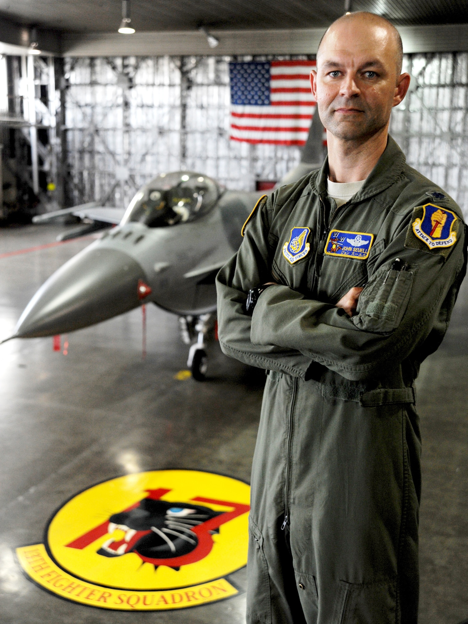 U.S. Air Force Lt. Col. John Seuell, 35th Operations Group deputy commander, stands over the seal of the 13th Fighter Squadron and an F-16 Fighting Falcon at Misawa Air Base, Japan, May 28, 2013. Seuell and his late father, Capt. John Wayne Seuell, both had ties to the 13th FS before his father was shot down in North Vietnam on June 6, 1972. (U.S. Air Force photo by Senior Airman Derek VanHorn)