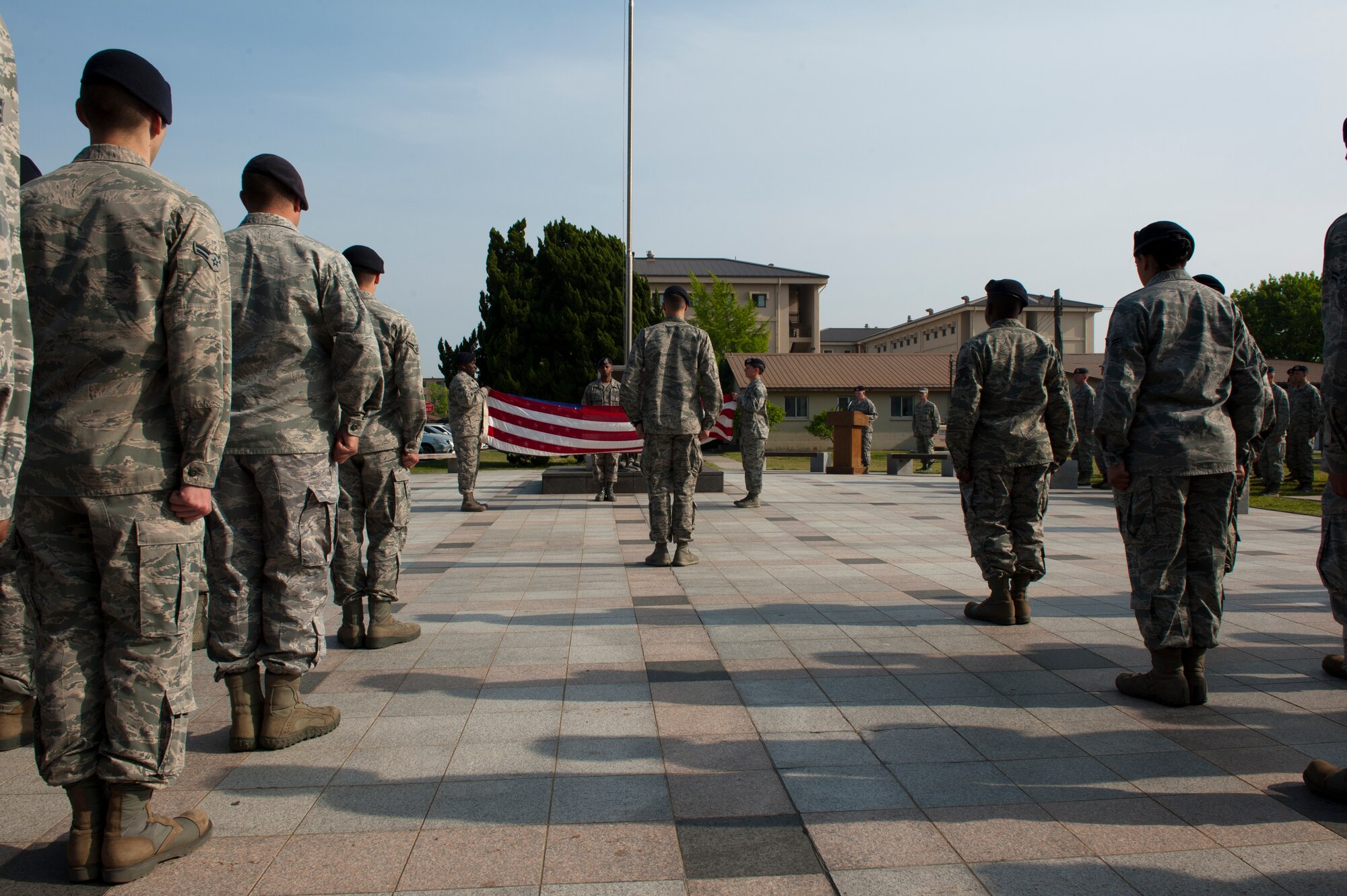 8th Security Forces Squadron members stand at attention while the flag is folded at Kunsan Air Base, Republic of Korea, May 15, 2013. The 8th SFS set up a special memorial retreat which recognized the efforts and sacrifices of law enforcement professionals. (U.S. Air Force photo by Staff Sgt. Jonathan Fowler/Released)