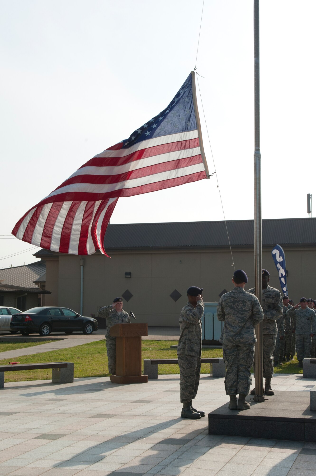 8th Security Forces Squadron members salute as the flag is lowered during a memorial retreat at Kunsan Air Base, Republic of Korea, May 15, 2013. The retreat was a special ceremony during National Police Week in honor of fallen law enforcement professionals. (U.S. Air Force photo by Staff Sgt. Jonathan Fowler/Released)
