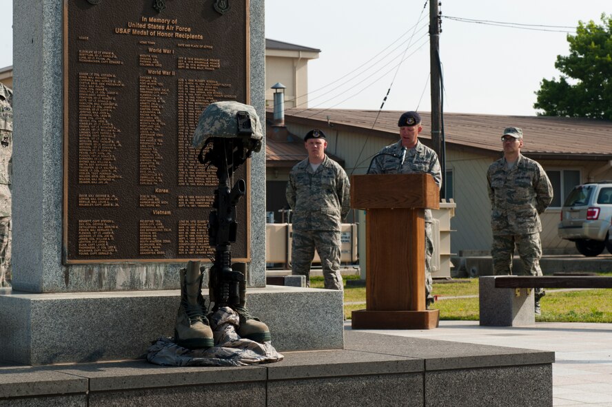 Lt. Col. Nathan Schalles, 8th Security Forces Squadron commander, speaks next to the POW/MIA memorial flag pole at Kunsan Air Base, Republic of Korea, May 15, 2013. This was part of a special memorial retreat ceremony during National Police Week, May 12 to 18. (U.S. Air Force photo by Staff Sgt. Jonathan Fowler/Released)