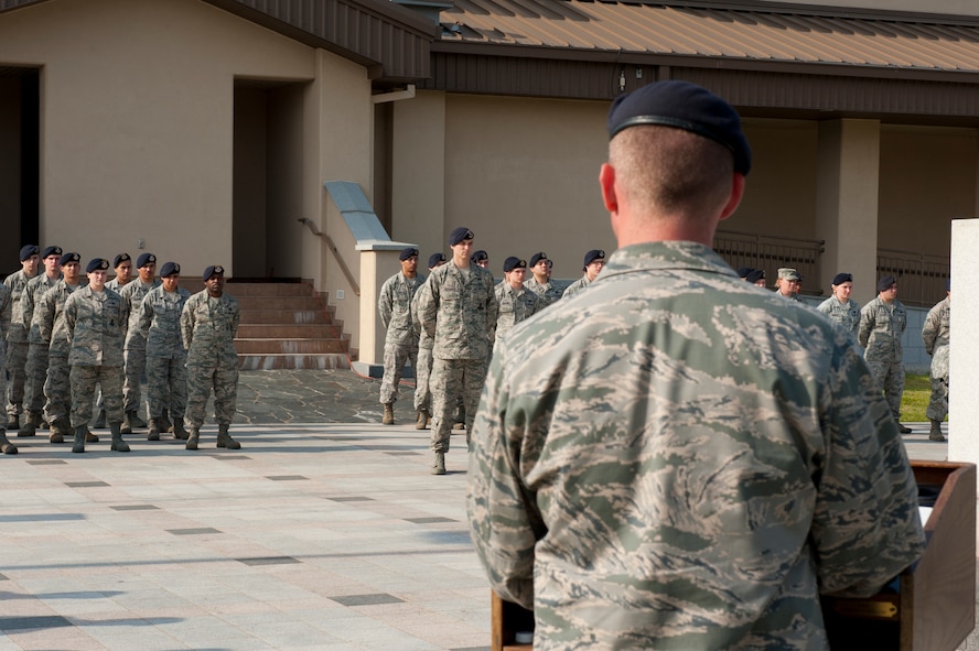 Lt. Col. Nathan Schalles, 8th Security Forces Squadron commander, gives a speech during a memorial retreat at Kunsan Air Base, Republic of Korea, May 15, 2013. 8th SFS members stood in formation while the names of members who died in the line of duty were read and the flag was lowered. (U.S. Air Force photo by Staff Sgt. Jonathan Fowler/Released)