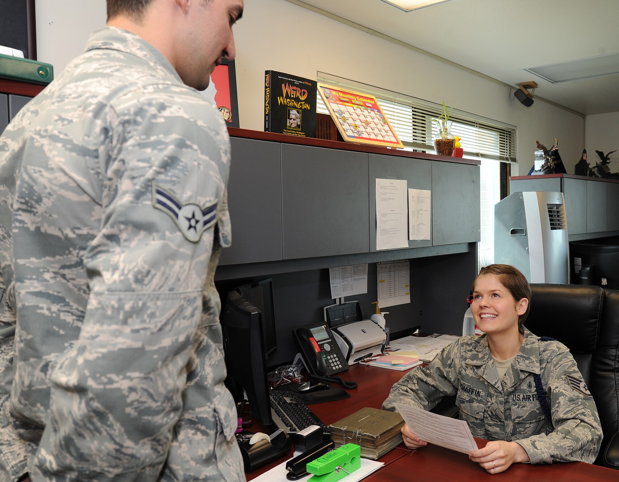 Staff Sgt. Julie Chaffin, 66th Training Squadron military training leader, speaks with a survival, evasion, resistance and escape student about charge of quarters duties at Fairchild Air Force Base, Wash., May 14, 2013. Chaffin has been selected as a member of Fairchild’s Finest. (U.S. Air Force photo by Airman 1st Class Janelle Patiño/Released)