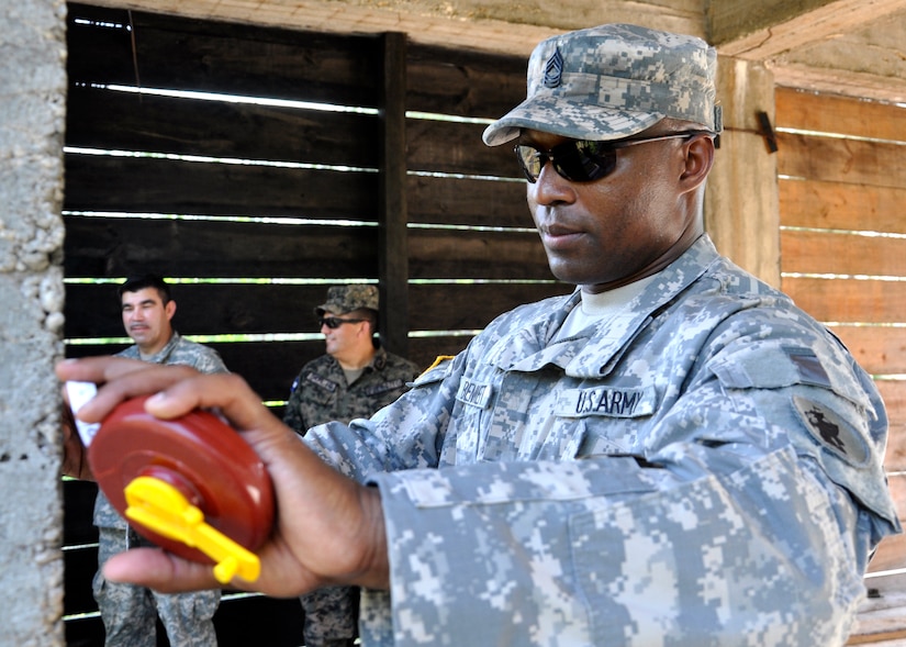 United States Army Master Sgt. Dunte Bennett Joint Task Force-Bravo Engineer Non-commissioned Officer in Charge takes measurements of the water storage facilities at the Honduran army base Mocoron, May 20. The team, led by Honduran military engineers, is conducting a topographical survey of the current infrastructure, to begin planning the next stage of facility upgrades. (U.S. Air Force photo by Staff Sgt. Eric Donner)