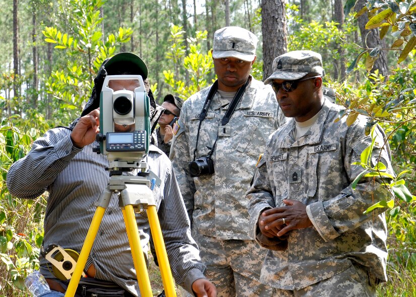 United States Army 1st Lt. Jonathan Logan, Joint Task Force-Bravo Engineer Project Officer, Master Sgt. Dunte Bennett, JTF-B Engineer Non-commissioned Officer in Charge assists a Honduran engineer surveying the fresh water source at the Honduran army base Mocoron, May 20. The team, led by Honduran military engineers, is conducting a topographical survey of the current infrastructure, to begin planning the next stage of facility upgrades. (U.S. Air Force photo by Staff Sgt. Eric Donner)