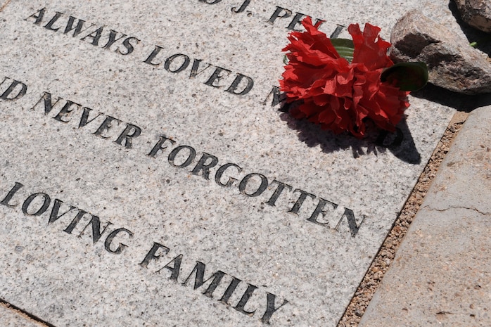 A flower rests on a memorial stone at the Southern Nevada Veterans Memorial Cemetery, Boulder City, Nev. during the Special Forces memorial, May 26, 2013. The event was held to honor Special Forces members from all wars who lost their lives defending their country. (U.S. Air Force photo by Tech. Sgt. Taylor Worley)