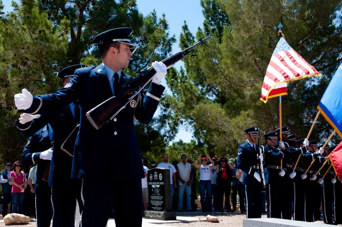 Nellis Air Force Base Honor Guard members pull the charging handles on their rifles during the Special Forces memorial service May 26, 2013, at the Southern Nevada Veterans Memorial Cemetery in Las Vegas. More than 300 people attended the service to pay respects to fallen veterans. (U.S. Air Force photo by Airman 1st Class Joshua Kleinholz)