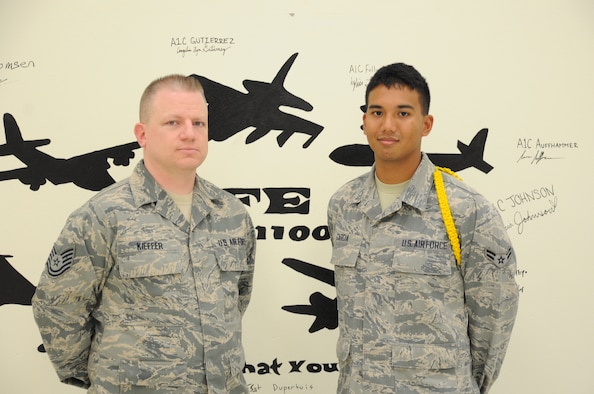From right to left, Airman 1st Class Iokepa Garcia and one of his instructors, Tech. Sgt. Eric Kieffer stand in an aircrew classroom. Garcia earned the ACE award, which is given for maintaining a 100 percent grade average throughout each block test. (U.S. Air Force photo by Airman 1st Class Jelani Gibson)   