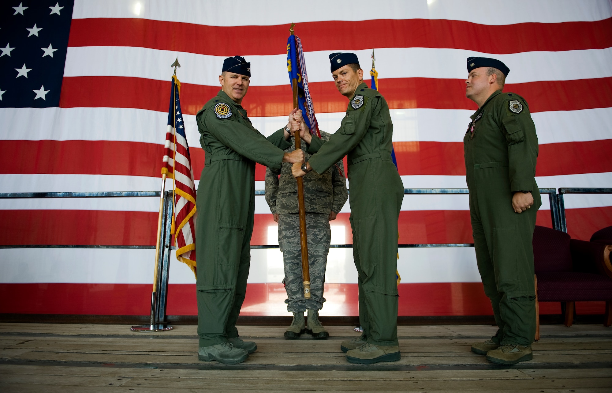 U.S. Air Force Col. Robert Garland Jr., U.S. Air Force Weapons School commandant, presents U.S. Air Force Lt. Col. Jonathan Creer, 77th Weapons Squadron commander, with the squadron guideon May 23, 2013, during a change of command ceremony at Dyess Air Force Base, Texas.  The ceremony is a military tradition deeply rooted in history and dates back to the times of the Roman Legion. In that period, military organizations developed flags that were unique to the organization with specialized colors and designs. When the soldiers followed their leaders into battle, they kept sight of the flag. If the banner still waved after the conflict, it was a sign that their side had won. Having this position of importance, the flag was incorporated into the change of command ceremonies. The organizational banner was exchanged in public for all to see that the one who holds the flag is the unchallenged leader of the armies. The modern day ceremony is principally symbolic, yet it still indicates to all the authority of the incoming commander in the finest military traditions. The outgoing commander surrenders the flag and says, “Sir, I relinquish the command.” The flag is then passed to the new commander who says, “Sir, I accept the command.” (U.S. Air Force photo by Airman 1st Class Damon Kasberg/Released) 