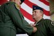 U.S. Air Force Col. Robert Garland Jr., U.S. Air Force Weapons School commandant, presents U.S. Air Force Lt. Col. Jeffrey Haynes, former 77th Weapons Squadron commander, with Meritorious Service Medal during a change of command ceremony May 23, 2013, at Dyess Air Force Base, Texas. The ceremony is a military tradition deeply rooted in history and dates back to the times of the Roman Legion. In that period, military organizations developed flags that were unique to the organization with specialized colors and designs. When the soldiers followed their leaders into battle, they kept sight of the flag. If the banner still waved after the conflict, it was a sign that their side had won. Having this position of importance, the flag was incorporated into the change of command ceremonies. The organizational banner was exchanged in public for all to see that the one who holds the flag is the unchallenged leader of the armies. The modern day ceremony is principally symbolic, yet it still indicates to all the authority of the incoming commander in the finest military traditions. The outgoing commander surrenders the flag and says, “Sir, I relinquish the command.” The flag is then passed to the new commander who says, “Sir, I accept the command.”  (U.S. Air Force photo by Airman 1st Class Damon Kasberg/Released)