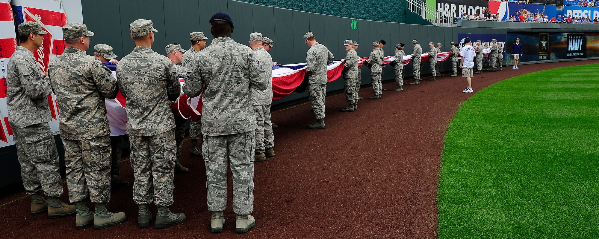 Thirty Airmen from Whiteman Air Force Base, Mo., display the American flag during the Kansas City Royals’ Armed Forces Day game against the St. Louis Cardinals game, May 27, 2013, at Kauffman Stadium in Kansas City, Mo. The special pregame ceremony included recognition of veterans, wounded warriors and a military family, as well as a tribute to fallen Soldiers and World War II veterans. (U.S. Air Force photo by Airman 1st Class Shelby Orozco/Released)