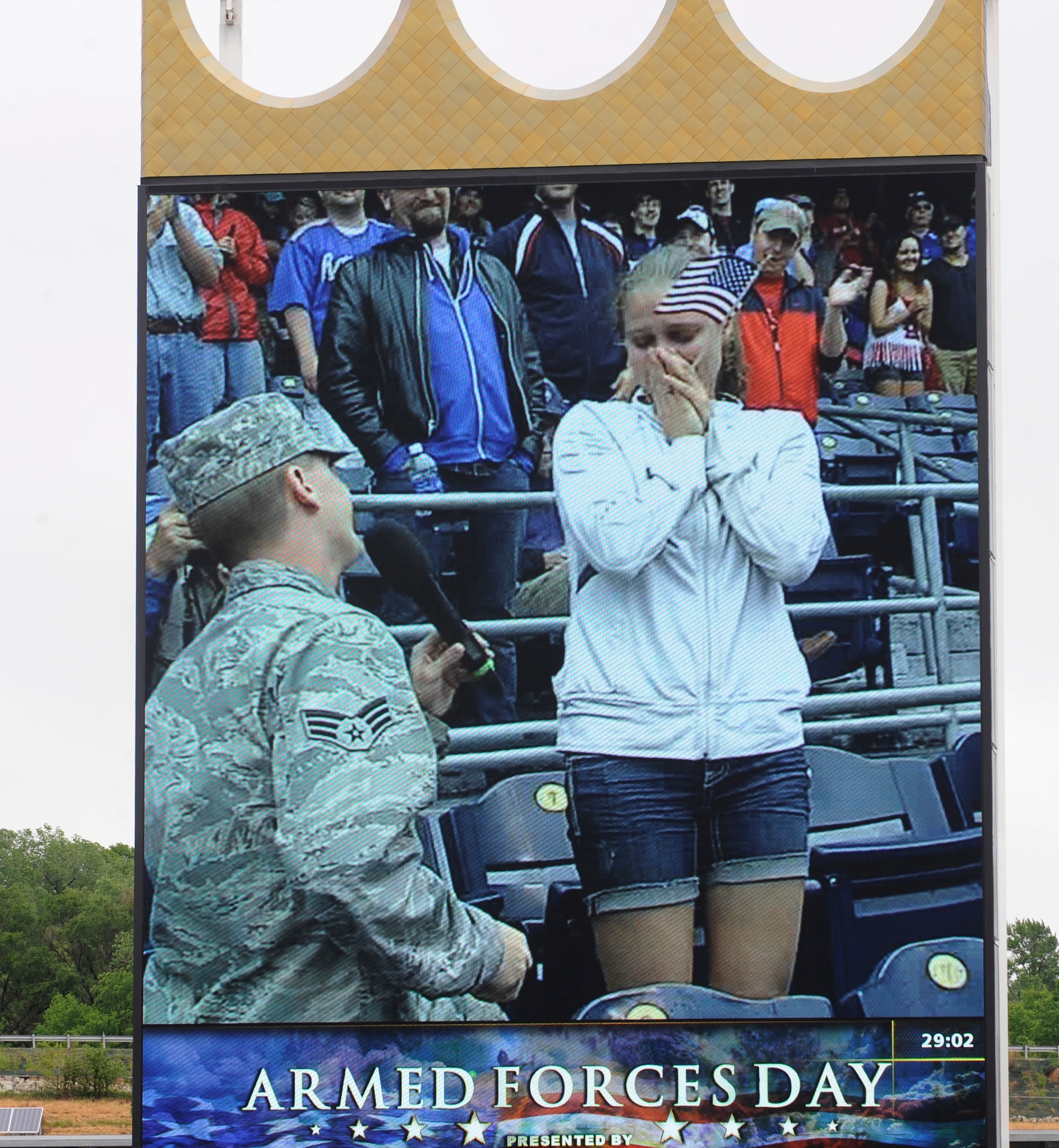 Senior Airman Ben Akers, from the 442nd Maintenance Squadron at Whiteman Air Force Base, Mo., proposes to his girlfriend, Kristen Opperman, at the Armed Forces Day game between the Kansas City Royals and Cardinals, May 27, 2013 at Kauffman Stadium in Kansas City, Mo. A special pregame ceremony honored the service of America’s men and women.  (U.S. Air Force photo by Staff Sgt. Alexandra M. Boutte/Released)