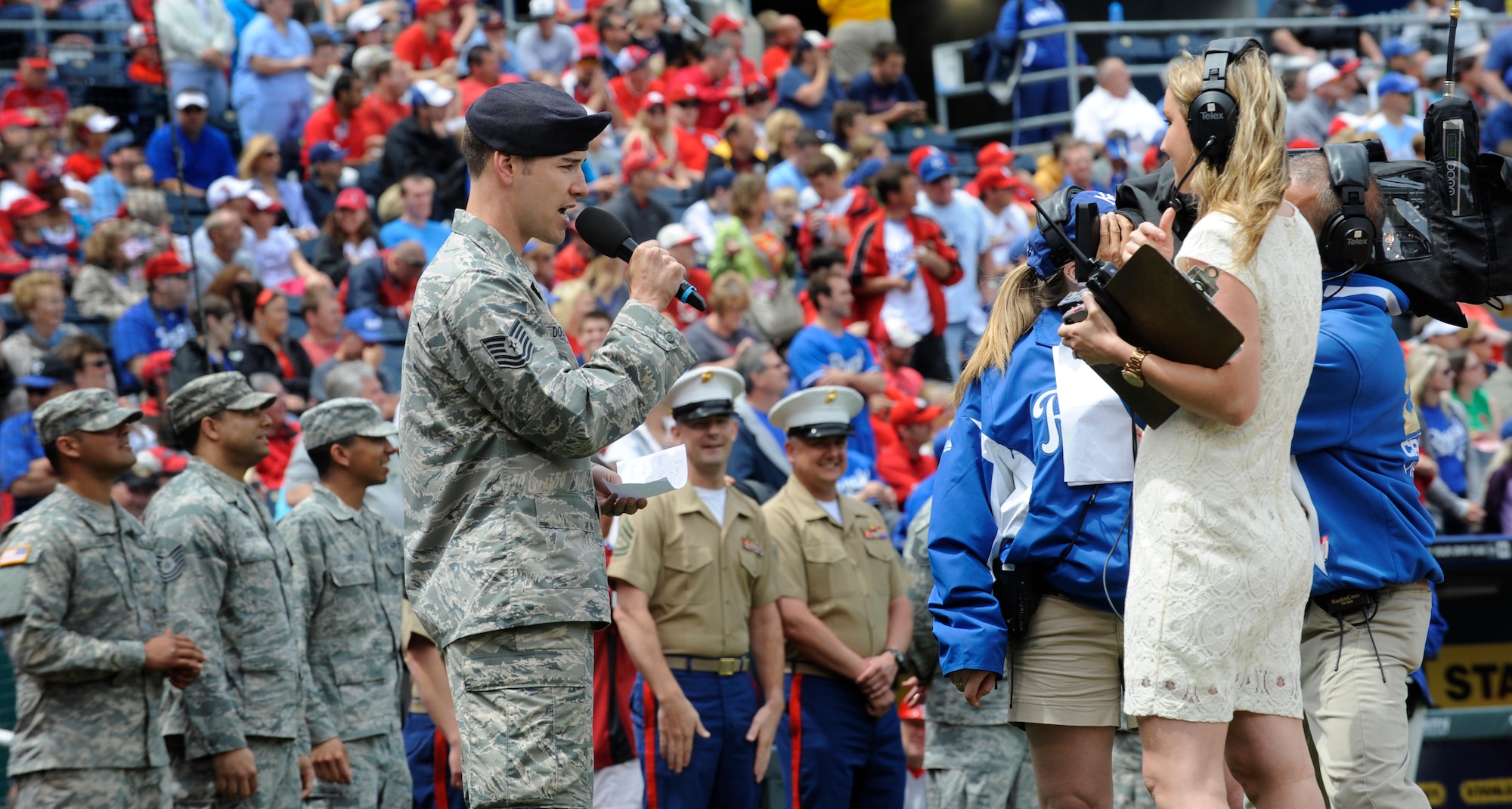 Tech. Sgt. Kyle Douglass, 509th Security Forces Squadron, announces a member of the Kansas City Royals during a special pregame ceremony honoring the military on Armed Forces Day, May 27, 2013 at Kauffman Stadium in Kansas City, Mo. The ceremony included recognition of veterans, wounded warriors and a military family, as well as a tribute to fallen Soldiers and World War II veterans. (U.S. Air Force photo by Staff Sgt. Alexandra M. Boutte/Released)