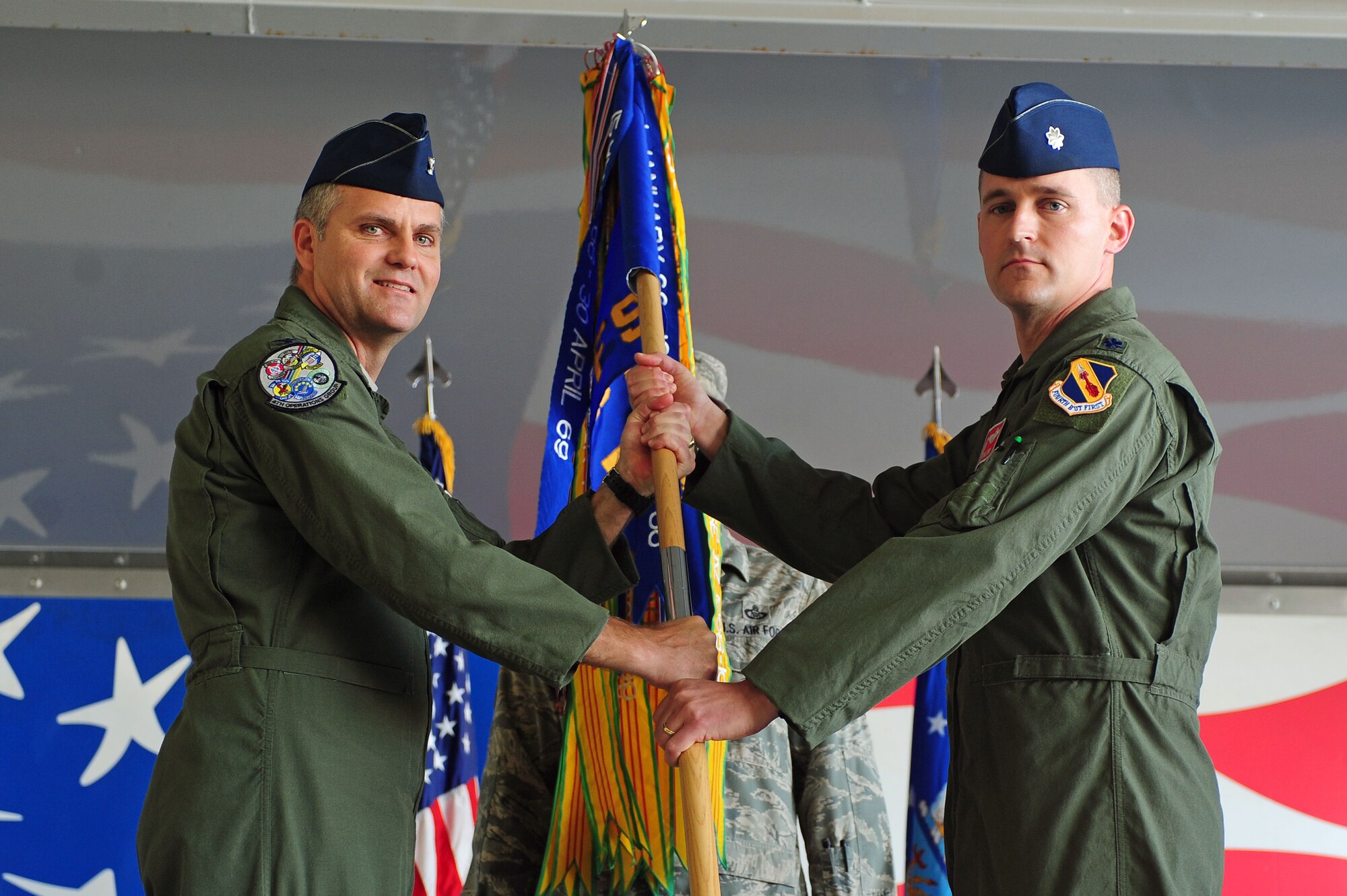 U.S. Air Force Lt. Col. Thomas Palmer, 333rd Fighter Squadron incoming commander, receives the guidon from Col. Michael Koscheski, 4th Operations Group commander, during a change of command ceremony at Seymour Johnson Air Force Base, N.C., May 17, 2013.  Palmer was formerly the 334th FS director of operations. (U.S. Air Force photo by Airman 1st Class John Nieves Camacho/Released)