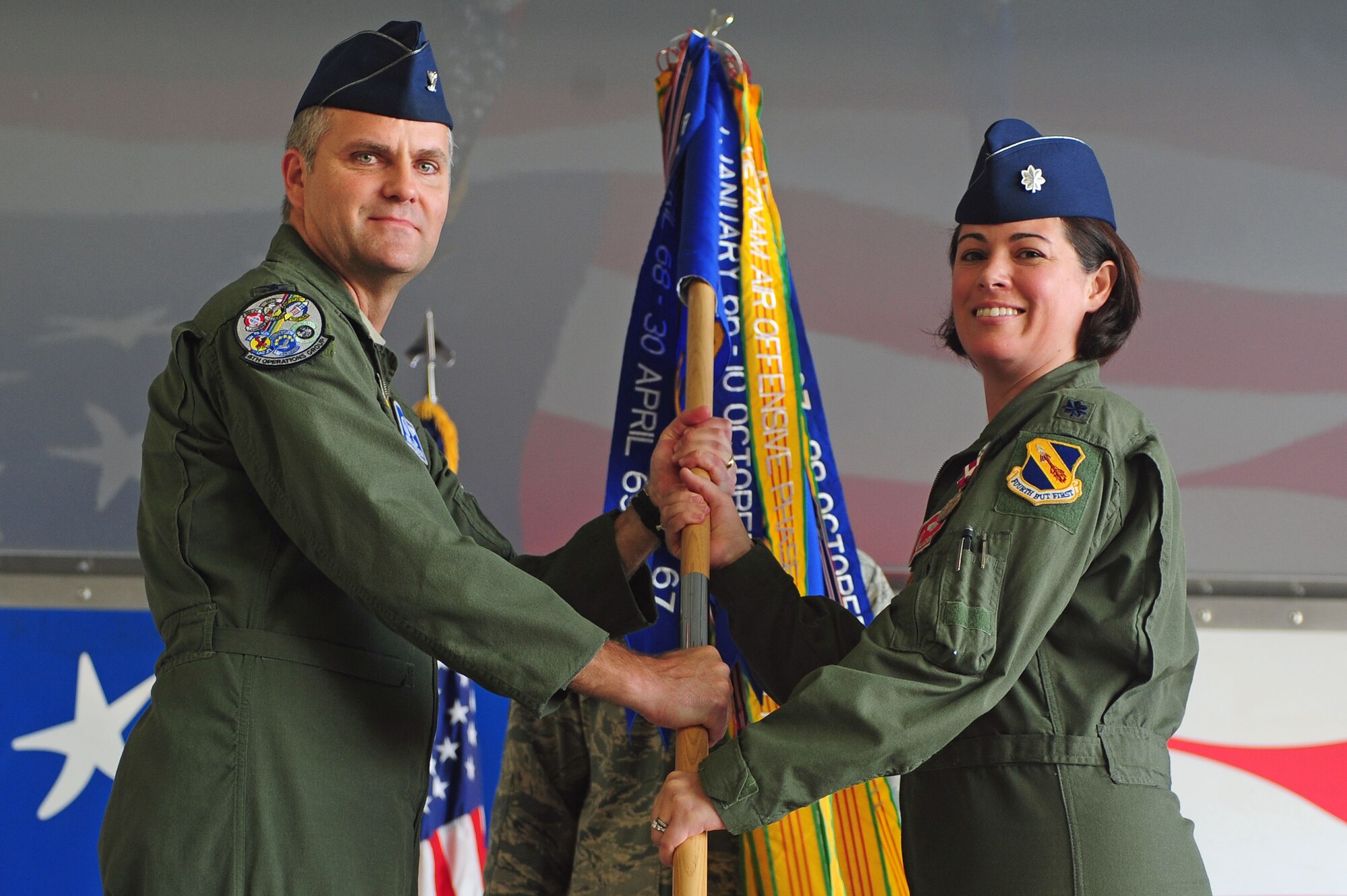 U.S. Air Force Lt. Col. Nicole Malachowski, 333rd Fighter Squadron out-going commander, passes the guidon to Col. Michael Koscheski, 4th Operations Group commander, during a change of command ceremony at Seymour Johnson Air Force Base, N.C., May 17, 2013.  Malachowski is departing to attend the Naval War College in Newport, Rhode Island.  (U.S. Air Force photo by Airman 1st Class John Nieves Camacho/Released)