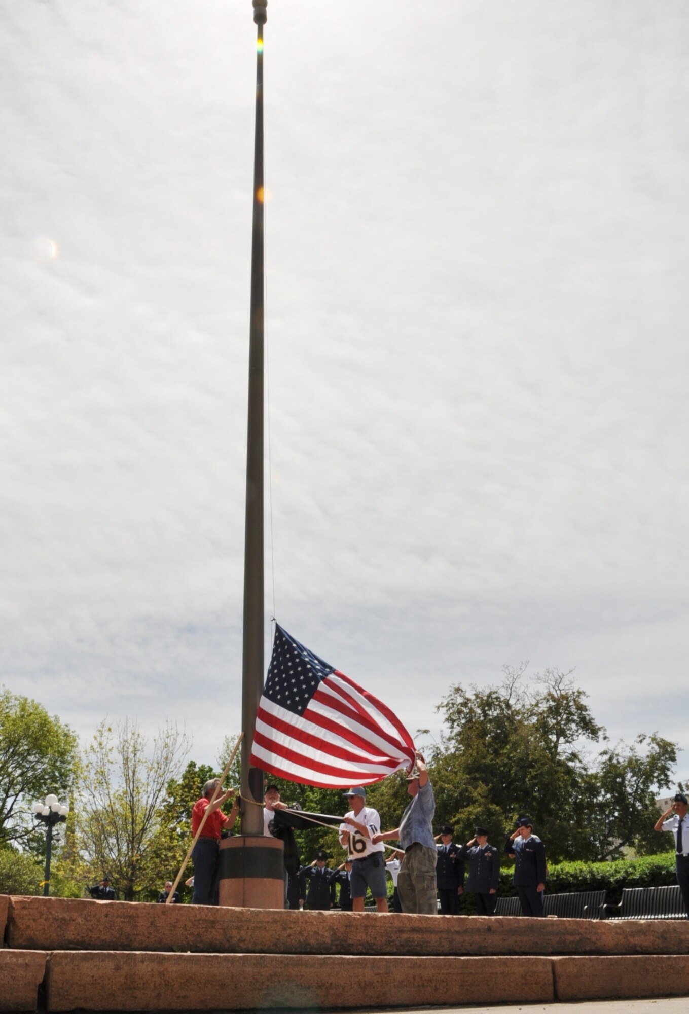 Salutes are rendered as the U.S. flag is raised at the Colorado Veterans Monument for a Veterans Memorial Day Tribute May 25, 2013, in Denver. The Prisoner-of-War/Missing-in-Action flag was also raised during the tribute, which followed the 2013 Memorial Day Parade honoring those who lost their lives while serving the U.S. (U.S. Air Force photo by Staff Sgt. Kali L. Gradishar/Released) 