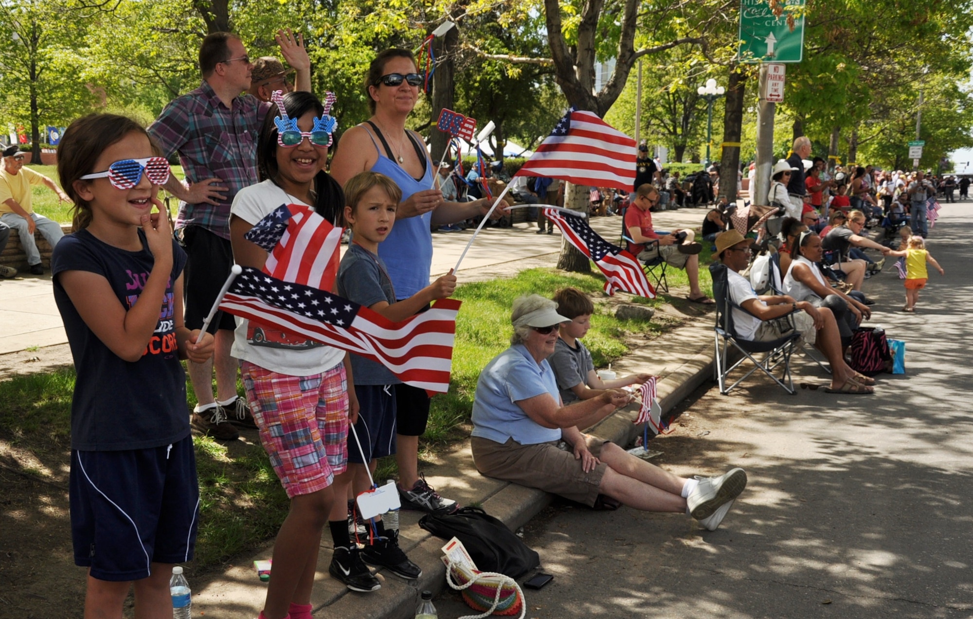 Spectators fly flags and wave during the 2013 Memorial Day Parade May 25, 2013, in Denver. Numerous spectators lined the streets near Civic Center Park to watch the approximately 40 parade entries. The parade was followed by a Veterans Memorial Day Tribute at the Colorado Veterans Monument on Broadway Ave. (U.S. Air Force photo by Staff Sgt. Kali L. Gradishar/Released)