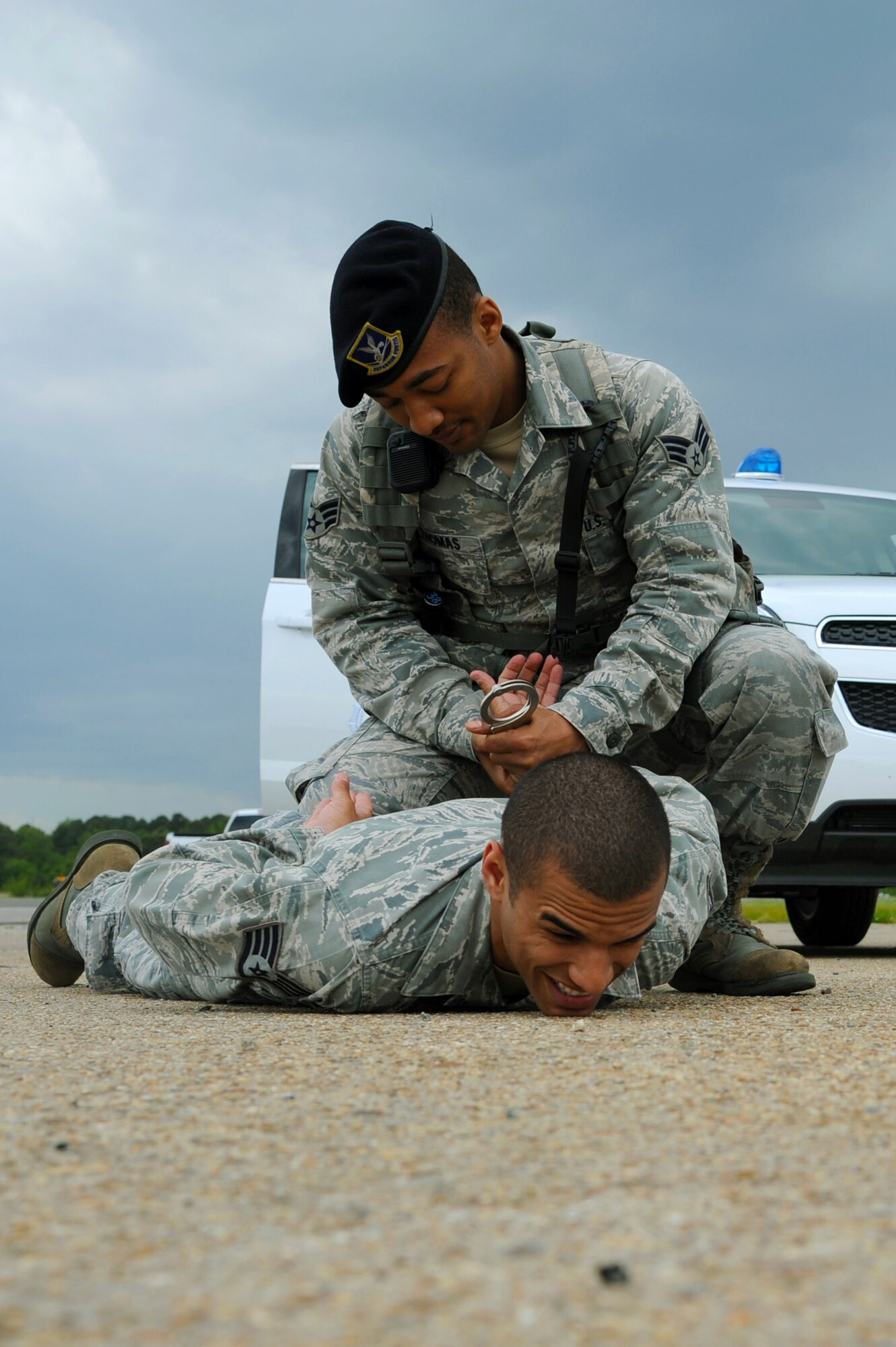 U.S. Air Force Senior Airman Andre Thomas, 633rd Security Forces Squadron response force leader, apprehends Staff Sgt. Trayshawn Humphries, 633rd SFS trainer, during a high-risk traffic exercise at Langley Air Force Base, Va., May 8, 2013. The Eagle Eyes program trains Airmen to remain vigilant and aware of various types of situations on the installation to mitigate possible threats. (U.S. Air Force photo by Airman 1st Class Victoria H. Taylor/Released)