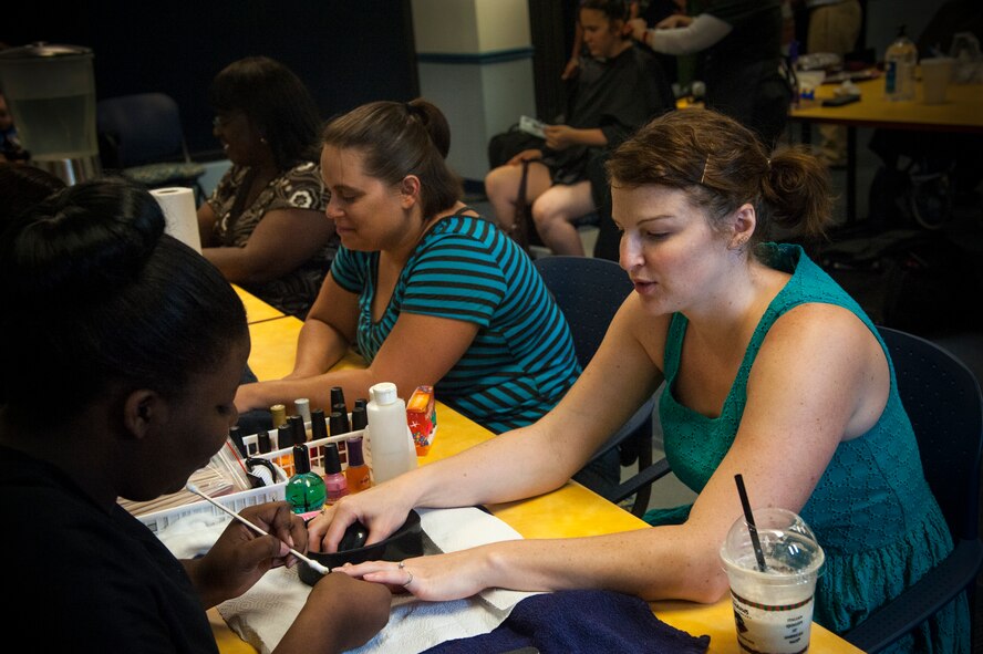 Janet Powell, wife of Staff Sgt. Matthew Powell, 23d Security Forces unit trainer, receives a manicure at Moody Air Force Base, Ga., May 22, 2013. The Airman and Family Readiness Center offered manicures, hair styling and hair cuts as part of the Pamper and Applaud Military Spouse Appreciation event.(U.S. Air Force photo by Airman 1st Class Sandra Marrero/Released)
