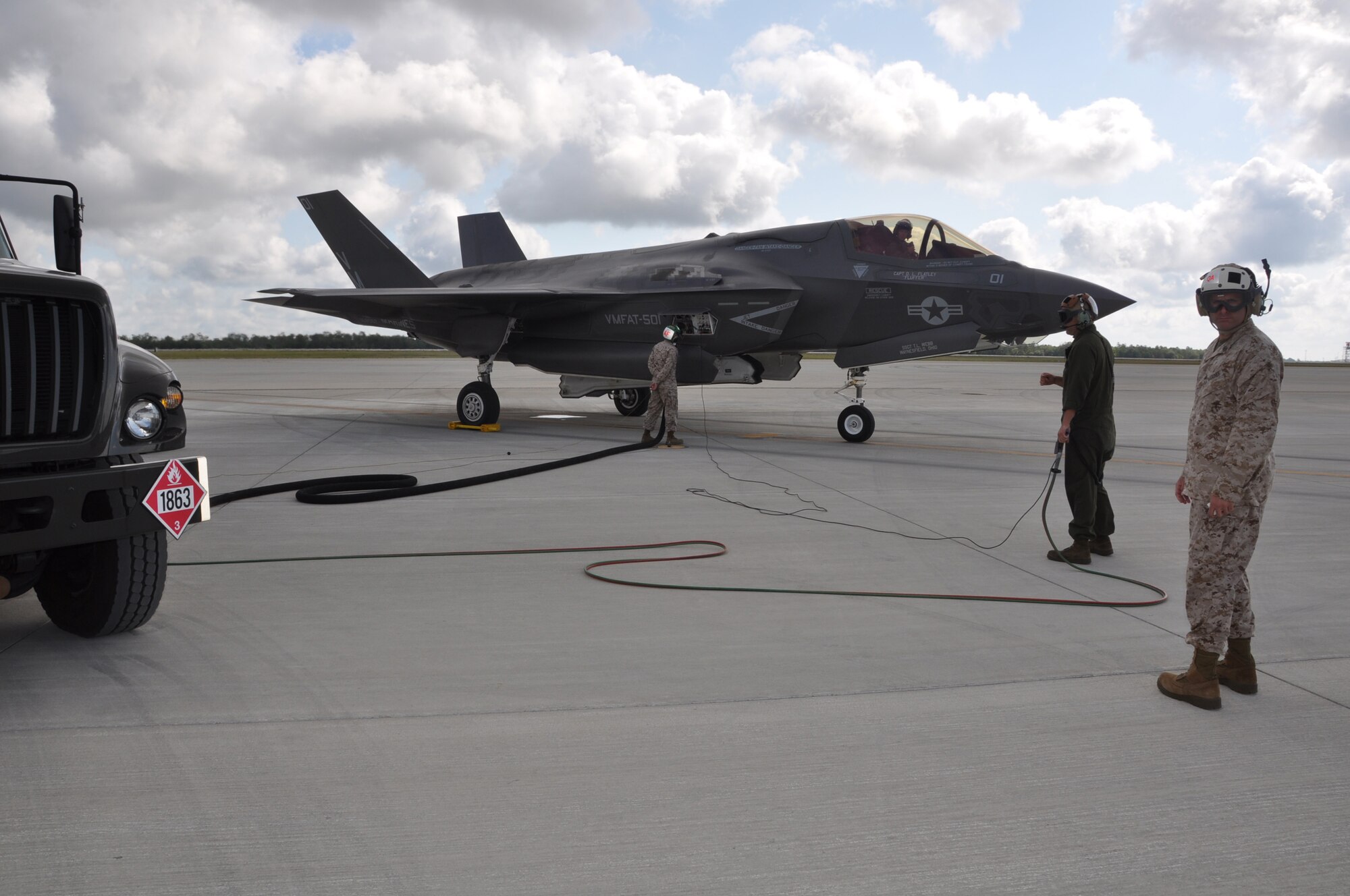 F-35B maintainers perform "hot" refueling of an F-35B Lightning II joint strike fighter at Eglin Air Force Base Fla., on May 22, 2013. In the year since the Marine Fighter Attack Training Squadron-501 flew its first F-35B mission at Eglin's 33d Fighter Wing, it's pilots have flown 833 local sorties and logged more than 1,100 flight hours. They also developed procedures for refueling the F-35B with the engine "hot" or running.  Eglin is the heart of F-35 training worldwide for the Air Force, Marines, Navy and international partner operators and maintainers of the Lightning II. (U.S. Air Force photo/Maj. Karen Roganov)

