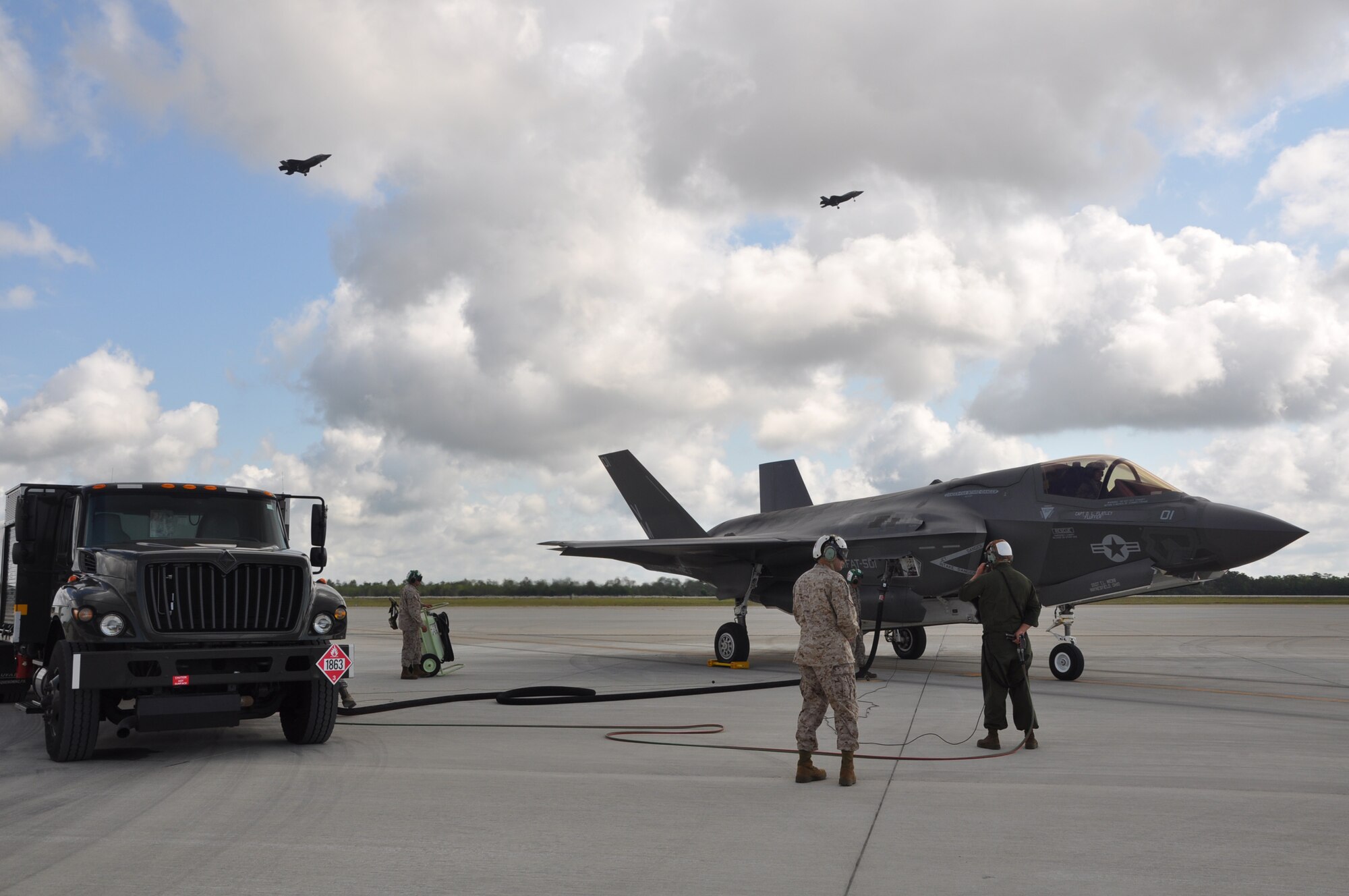 Marine maintainers and an Airman fuels journeyman perform “hot” refueling of an F-35B Lightning II joint strike fighter at Eglin Air Force Base Fla., May 22, 2013. Cpl. Julian Morales; Sgt. Robert Coates; Sgt. Sean Fagan and Airman First Class Benjamin Nutt are one of a two-station team of trucks and maintainers that refueled four jets to complete eight sorties in about three hours. Eglin is the heart of F-35 training worldwide for the Air Force, Marines, Navy and international partner operators and maintainers of the Lightning II. (U.S. Air Force photo/Maj. Karen Roganov)