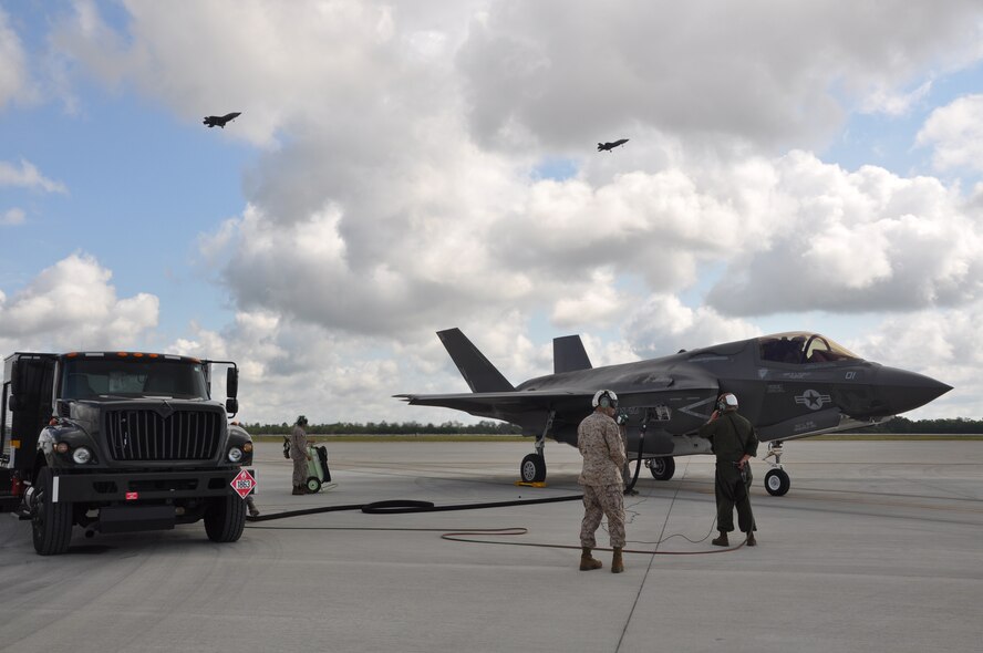 Marine Corps maintainers and an Airman fuels journeyman perform “hot” refueling of an F-35B Lightning II joint strike fighter at Eglin Air Force Base Fla., May 22, 2013. Cpl. Julian Morales; Sgt. Robert Coates; Sgt. Sean Fagan and Airman First Class Benjamin Nutt are one of a two-station team of trucks and maintainers that refueled four jets to complete eight sorties in about three hours. Eglin is the heart of F-35 training worldwide for the Air Force, Marines, Navy and international partner operators and maintainers of the Lightning II. (U.S. Air Force photo/Maj. Karen Roganov) 
