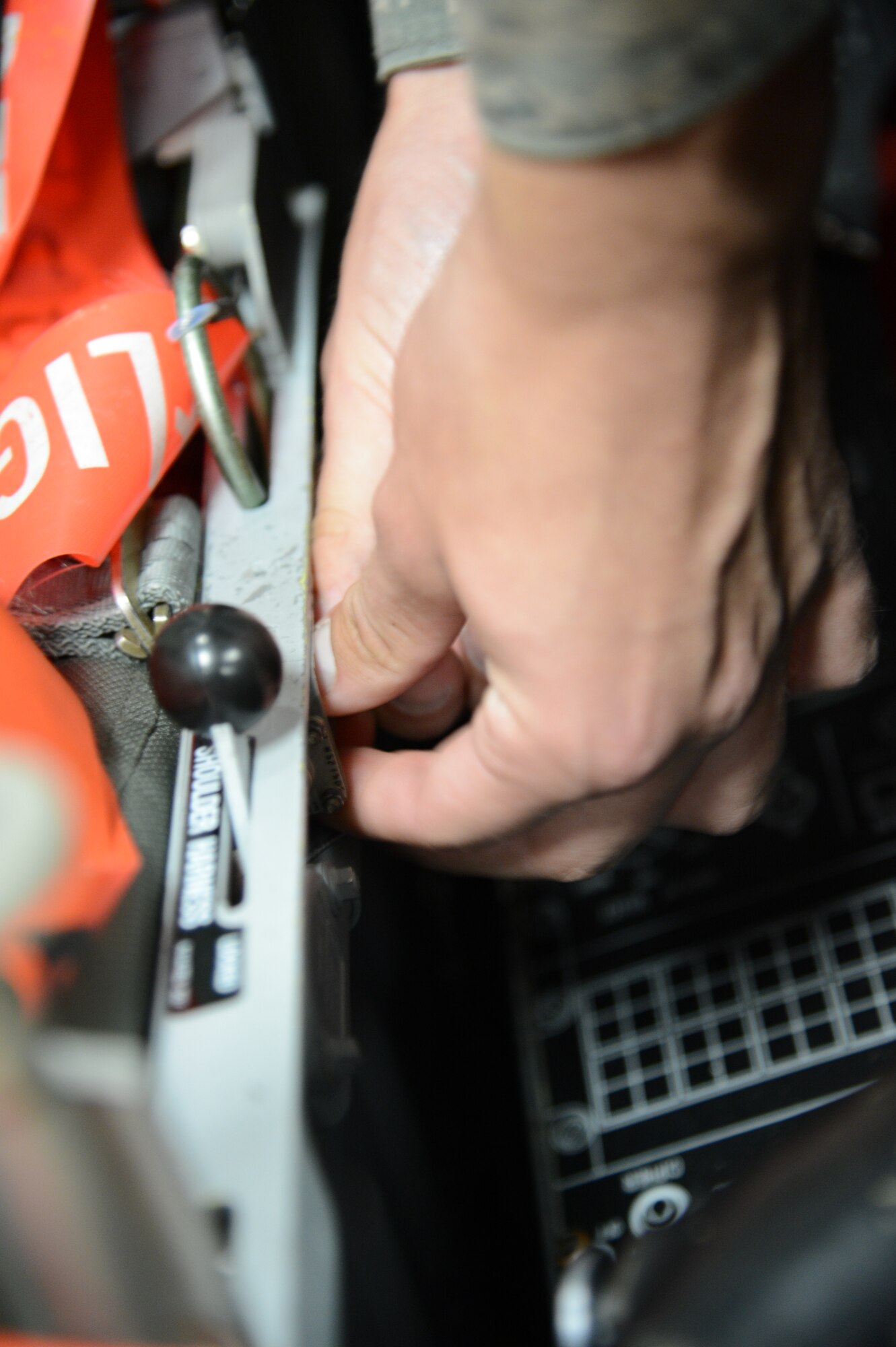 A Detachment 202 372nd Training Squadron egress student works on the seat of an F-16 Fighting Falcon, May 22, 2013, Shaw Air Force Base, S.C..Egress is one of nine career fields taught at Det. 202 372nd TRS. (U.S. Air Force photo by Airman 1st Class Jonathan Bass/Released)