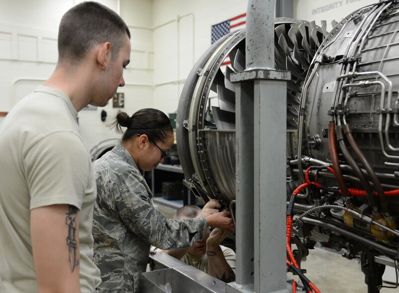 U.S. Air Force Airman 1st Class Brenton Repine, an F-16 maintainer student with Detachment 202, 372nd Training Squadron here, observes as Airman 1st Class Carissa Barrera, an F-16 maintainer student with Detachment 202, 372nd Training Squadron here, works on an F-16 Fighting Falcon engine on May 22, 2013, Shaw Air Force Base, S.C. Hands on training is a large part of the course at Detachment 202, 372nd Training Squadron. (U.S. Air Force photo by Airman 1st Class Jonathan Bass/Released)