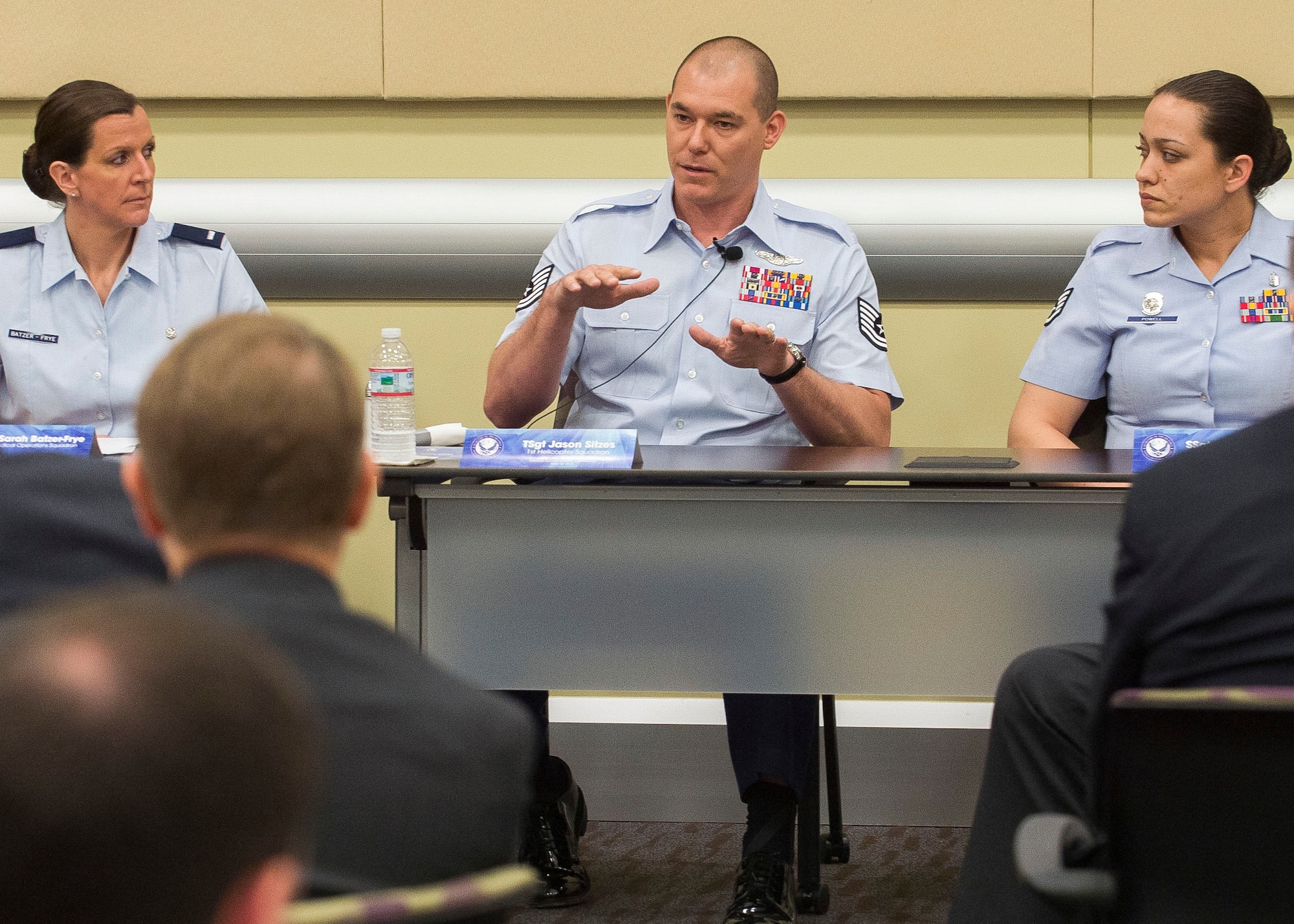 Tech. Sgt. Jason Sitzes (center), an evaluator flight engineer assigned to the 1st Helicopter Squadron, 11th Wing, Joint Base Andrews, Md., describes a mission he was on while deployed to Afghanistan during the Air Force's annual National Security Scholars Conference being held at Joint Base Andrews, Md. on May 16, 2013. Sitzes, along with: 1st Lt. Sarah Batzer-Frye, a critical care nurse working for the tri-service team at Fort Belvoir Community Hospital, Fort Belvoir, Va., and Staff Sgt. Jennifer Powell, a pallbearer with the U.S. Air Force Honor Guard at Joint Base Anacostia-Bolling, talked about their Air Force experiences and answered questions from conference attendees. Jointly hosted by the Secretary of the Air Force Michael Donley and Air Force Chief of Staff Gen. Mark A. Welsh III, the annual forum brings Air Force senior leaders and foreign policy and international security experts together to discuss the Air Force's strategic direction and its contribution to national defense. (U.S. Air Force photo by Jim Varhegyi)