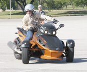 Bill James, JBSA-Lackland traffic safety manager, runs through a motorcycle safety course aboard a three-wheel motorcycle during a motorcycle safety rally at the Joint Base San Antonio-Lackland Medina Annex April 12. (Air Force photo by Robbin Cresswell, JBSA-Lackland Public Affairs)