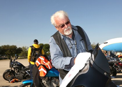 Terry Ashcraft, 802nd Civil Engineer Squadron, polishes the windshield on his motorcycle. Ashcraft has been a motorcycle enthusiast for 48 years. (Air Force photo by Robbin Cresswell, JBSA-Lackland Public Affairs)