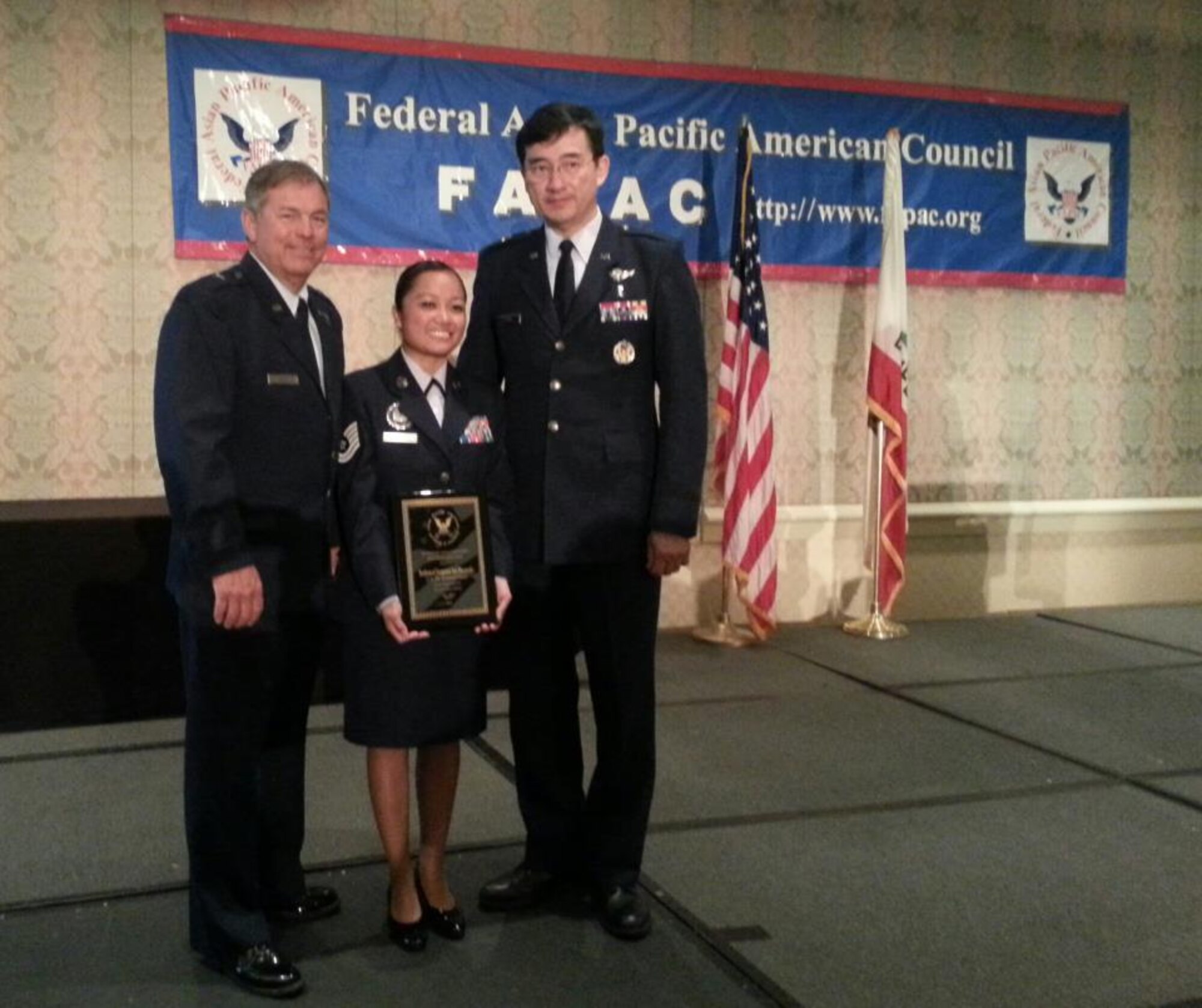 Tech. Sgt. Iris Honrado, Wyoming Air National Guard production recruiter, receives the Federal Asian-Pacific American Heritage Council's Meritorious Service Award from Deputy Adjutant General-Air Brig. Gen. Harold Reed, and Brig. Gen. Jim Chow, Air National Guard special assistant to the director, at a ceremony held in Long Beach, Calif., May 8, 2013. The FAPAC MSA recognizes military members who foster an innovative and harmonious environment between the military and the Asian Pacific American civilian community and assist the work force in overcoming discrimination and eliminating barriers that hinder equal opportunity for APAs and other minorities in the armed forces. (Courtesy photo)