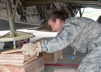 Air Force Personnel from the 76th Aerial Port Squadron and Travel Management Office here, and the 512th Airlift Wing, Dover Air Force Base, Delaware, guide a school bus up the nose ramp of a C-5M Super Galaxy aircraft here, May 24. The school bus, donated by Ohio-based charity Hope for Haiti’s Children, is being transported to Haiti via the Denton program.