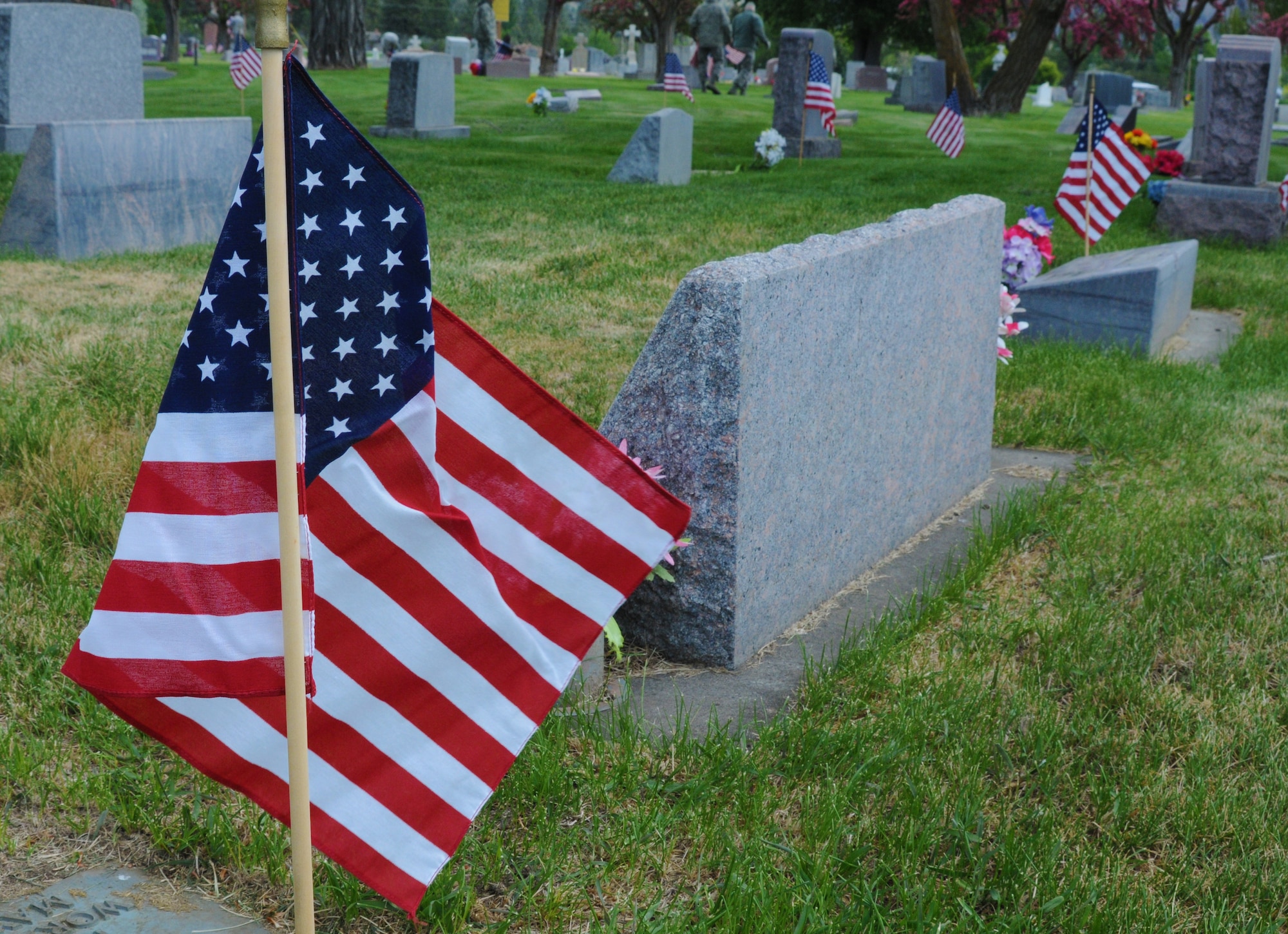 U.S. flags decorate the graves of local veterans at Mount Calvary Cemetery in Klamath Falls, Ore. May 23, 2013.  Airman from the 173rd Fighter Wing spent their morning placing flags in honor of Memorial Day.  (U.S. Air National Guard photo by Master Sgt. Jennifer Shirar) RELEASED  