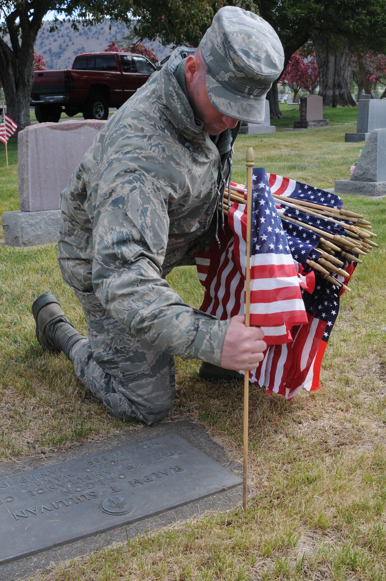 U.S. Air National Guard Staff Sgt. Jared Nanneman, 173rd Fighter Wing, places a flag on the graves of local veterans at Mount Calvary Cemetery in Klamath Falls, Ore. May 23, 2013.  Members of the 173rd Fighter Wing spent their morning placing flags in honor of Memorial Day.  (U.S. Air National Guard photo by Master Sgt. Jennifer Shirar) RELEASED  