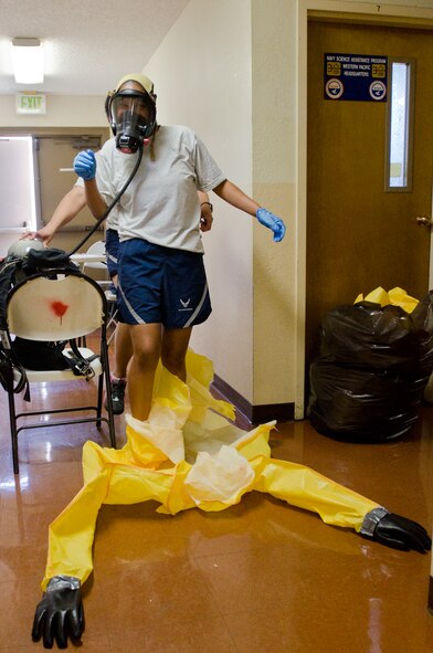 A U.S. Airman assigned to the California National Guard’s Homeland Response Force (HRF) exits a protective suit during a hazardous materials certification test at Naval Base Coronado, Calif., May 22, 2013. More than 100 Airmen from the Missouri and California National Guard’s HRF received emergency response training on natural disasters and domestic terrorist attacks. (U.S. Air National Guard photo by Tech. Sgt. Michael Crane/Released)