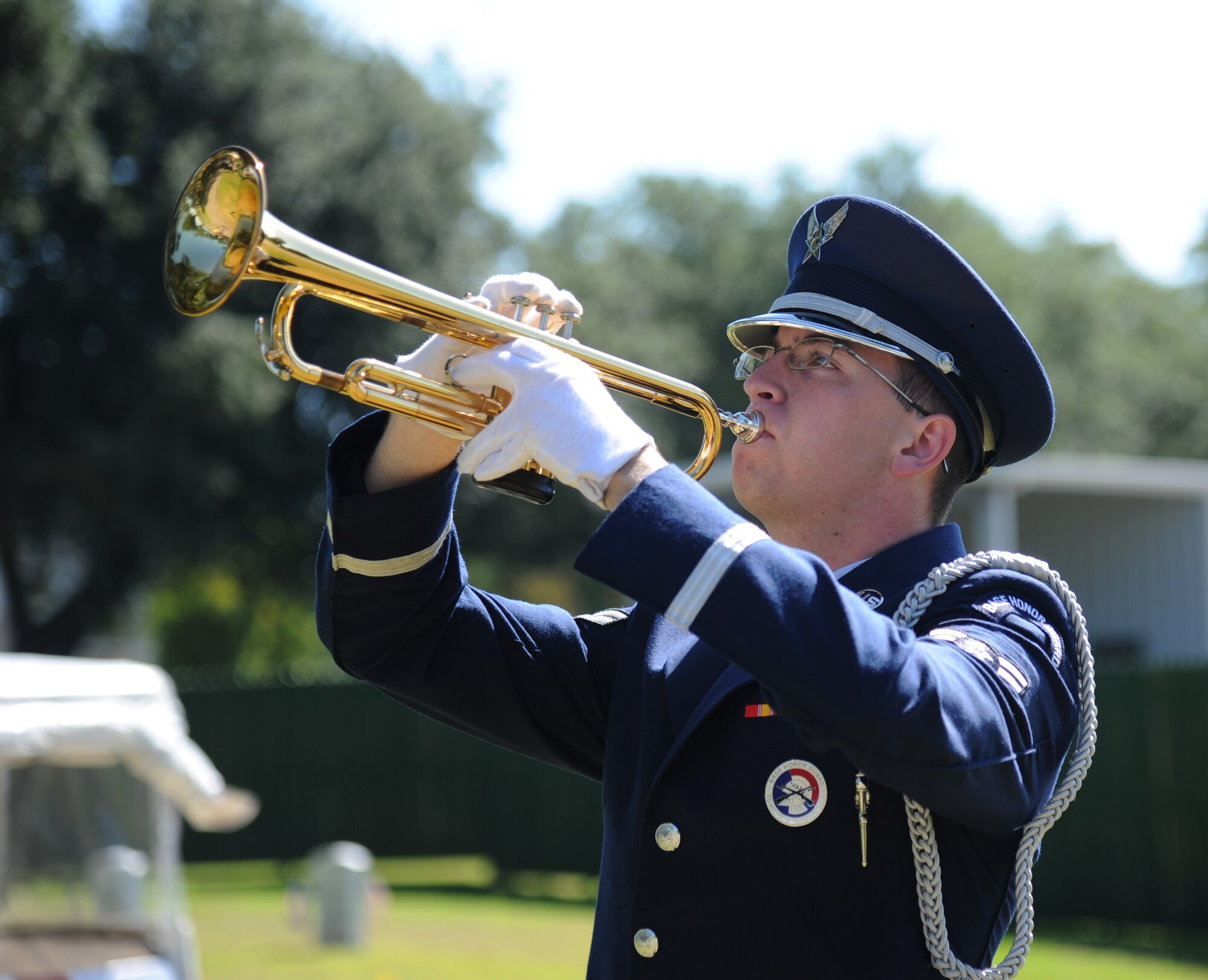 Airman 1st Class Jacob Oakes, Keesler Honor Guard, plays ‘Taps’ during a Memorial Day ceremony at the Biloxi National Cemetery May 27, 2013. More than 200 community representatives, veterans and family members attended the event.  (U.S. Air Force photo by Kemberly Groue)