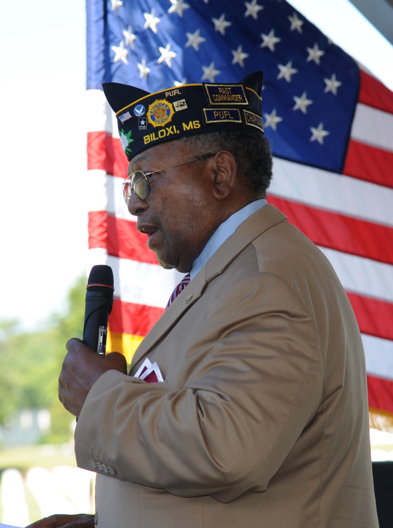Retired Chief Master Sgt. Chris Moore sings ‘God Bless America’ during a Memorial Day ceremony at the Biloxi National Cemetery May 27, 2013. Brig. Gen. Brad Spacy, 81st Training Wing commander, was the keynote speaker for the event where he talked to more than 200 community representatives, veterans and family members attend about the many sacrifices made by veterans and the price of freedom today.   The Keesler Honor Guard also participated in the event.  (U.S. Air Force photo by Kemberly Groue)