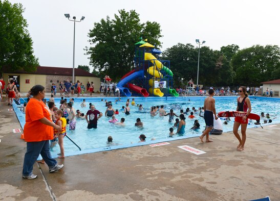 Pool Bash guests swim and play at the North Gate Pool on Barksdale Air Force Base, La., May 24, 2013. The Pool Bash was held for the grand re-opening of the pool after several renovations were made. During the event, refreshments, music and free pool toys were provided for participants to enjoy. (U.S. Air Force photo/Senior Airman Micaiah Anthony)