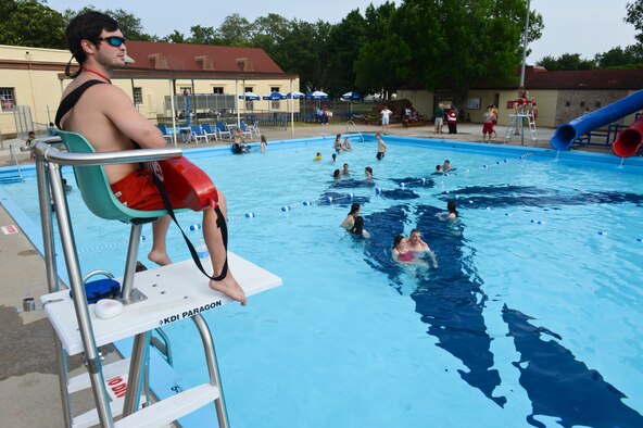 A lifeguard keeps watch as Pool Bash guests swim at the North Gate Pool on Barksdale Air Force Base, La., May 24, 2013. The North Gate Pool offers swim lessons, pool parties and lap swimming for everyone with base access. (U.S. Air Force photo/Senior Airman Micaiah Anthony)