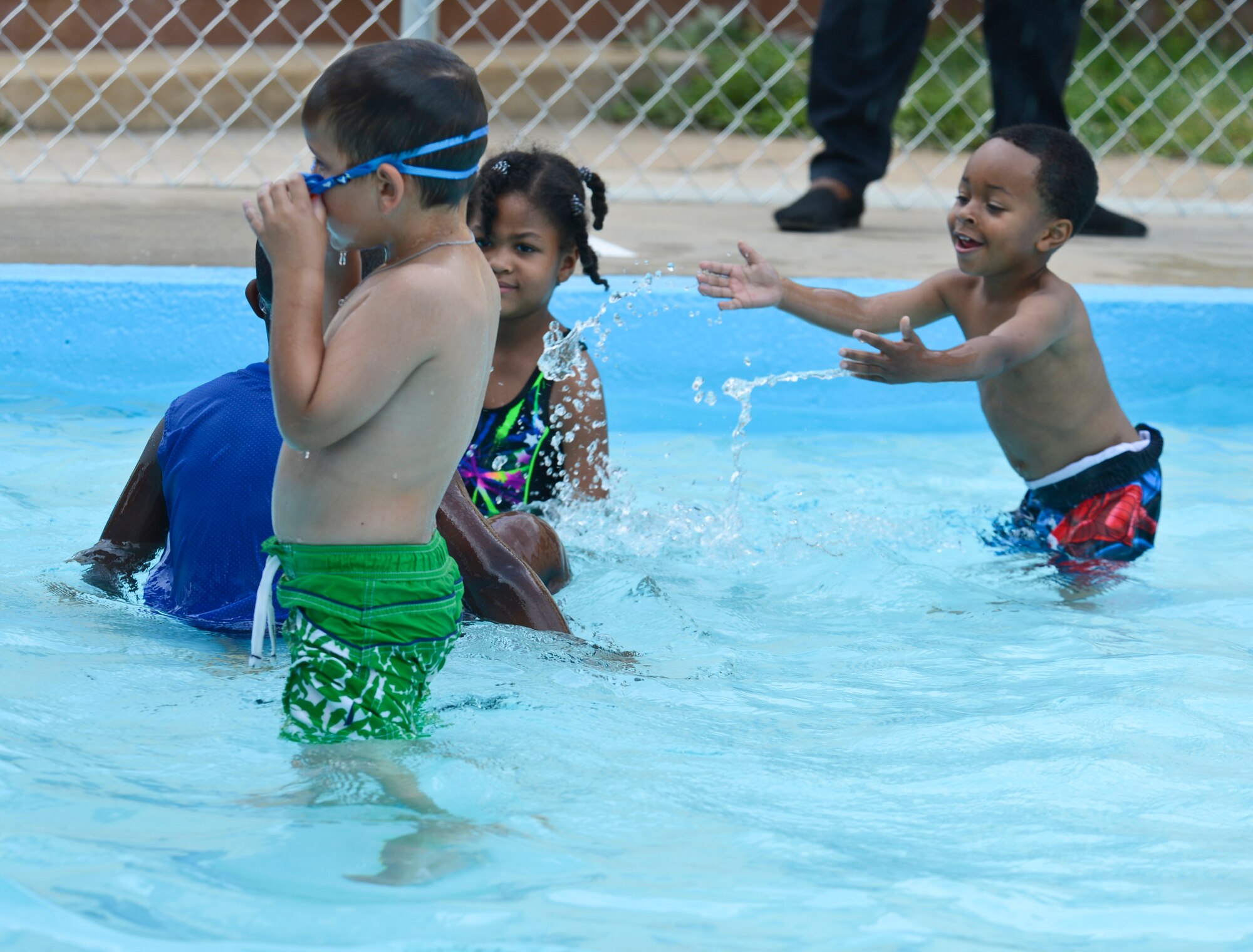 Children play in the water at the North Gate Pool during the Pool Bash on Barksdale Air Force Base, La., May 24, 2013. The pool area received several new additions such as a concession stand, renovated bathrooms, four large waterslides and a salt water chlorination machine. (U.S. Air Force photo/Senior Airman Micaiah Anthony)
