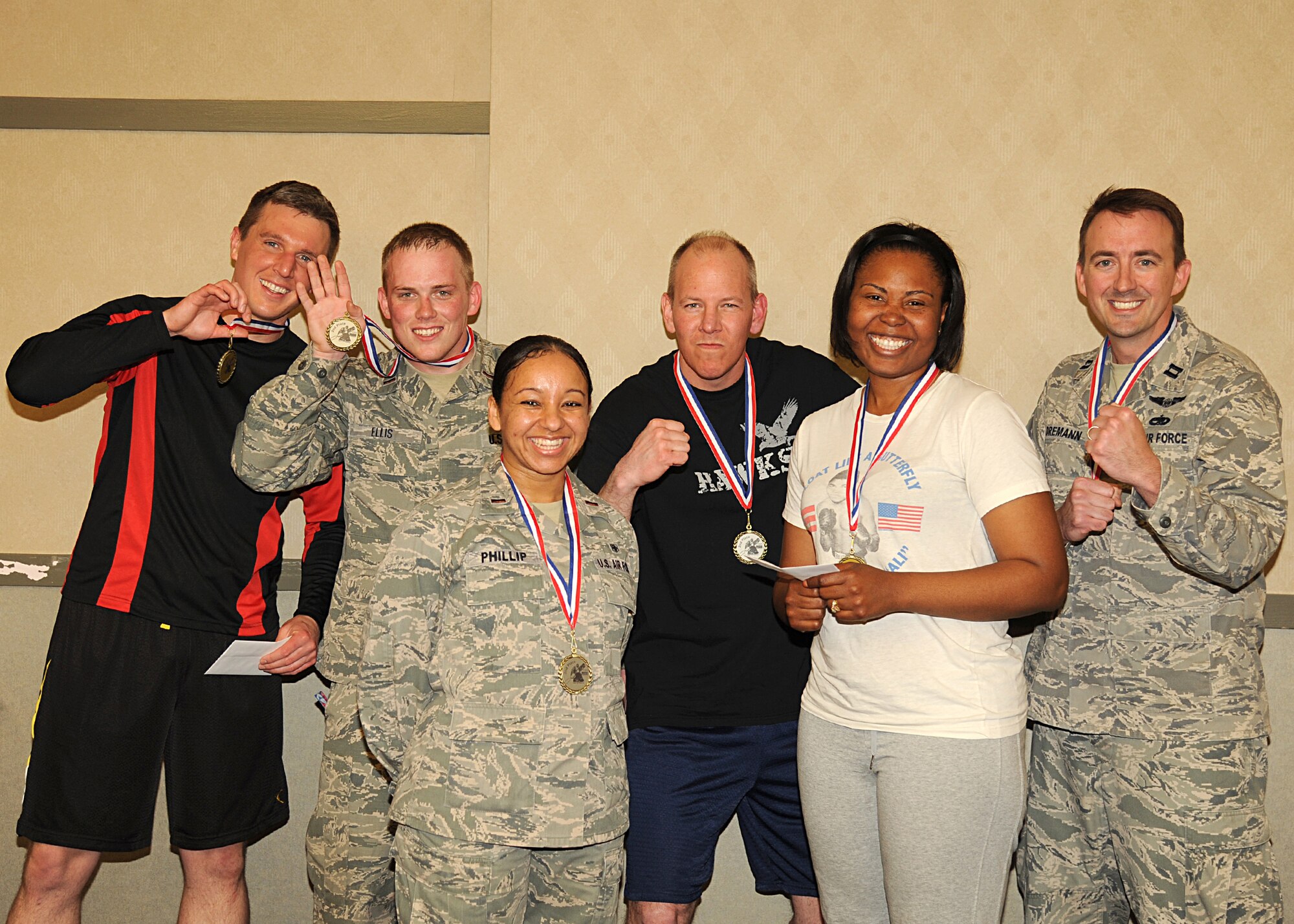 Winners of the Ultimate Pugil Challenge present there medals, May 21, 2013, at the Northern Lights Club, on Grand Forks Air Force Base, N.D. First place winners of the male and female bracket were each awarded a $50-gift card and a medal. (U.S. Air Force photo/Airman 1st Class Xavier Navarro)
