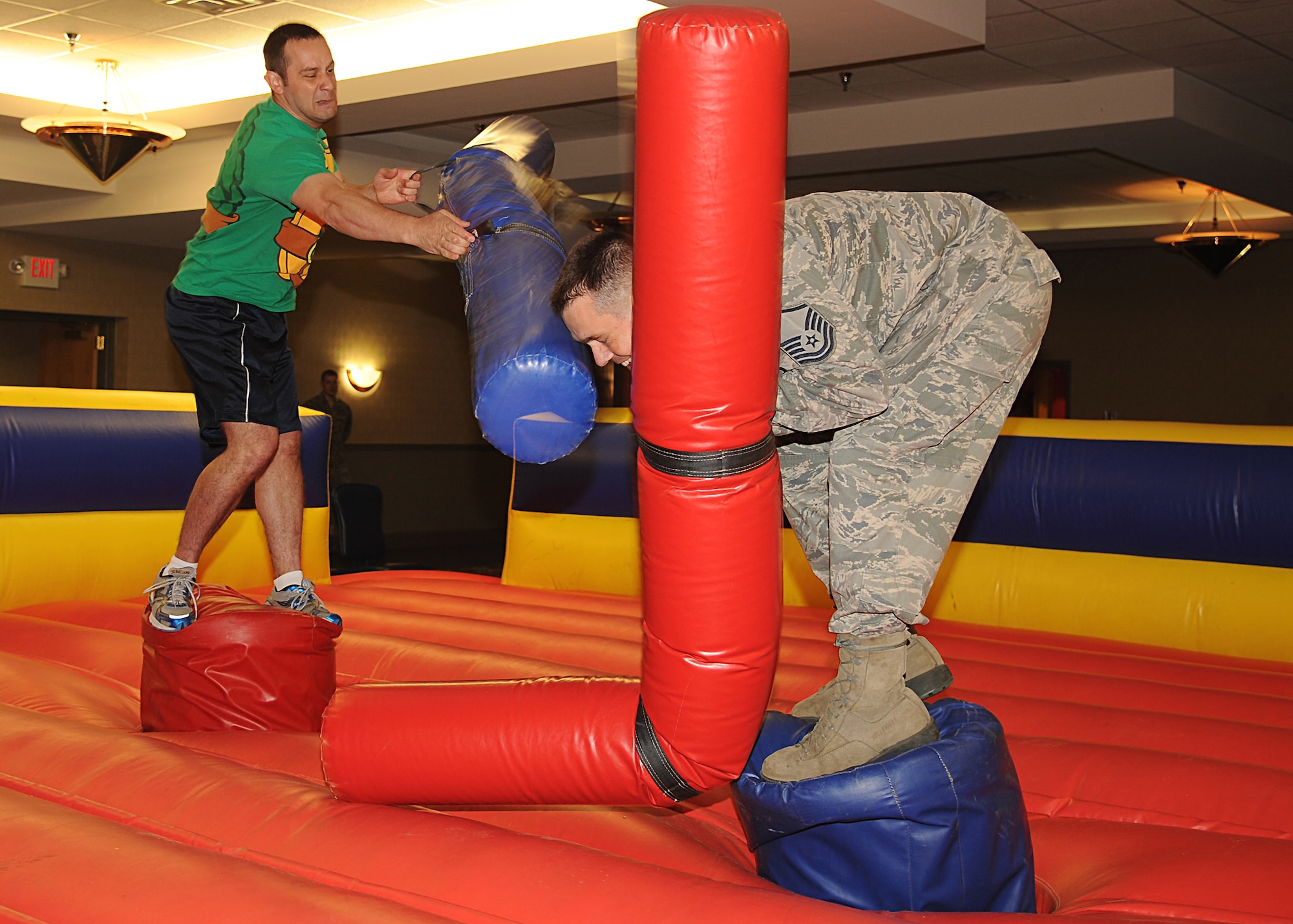 Master Sgt. Herbert Elliot gets whacked by a pugil stick on May 21, 2013, at the Northern Lights Club on Grand Forks Air Force Base, N.D. Twenty-two competitors fought their way up the bracket to be awarded medals and receive prizes for the first place winners at the Ultimate Pugil Challenge hosted by the 319th Force Support Squadron. The 69th Reconnaissance Group was awarded the “Top Unit” Trophy, for having the most winners out of the winner’s bracket. (U.S. Air Force photo/Airman 1st Class Xavier Navarro)