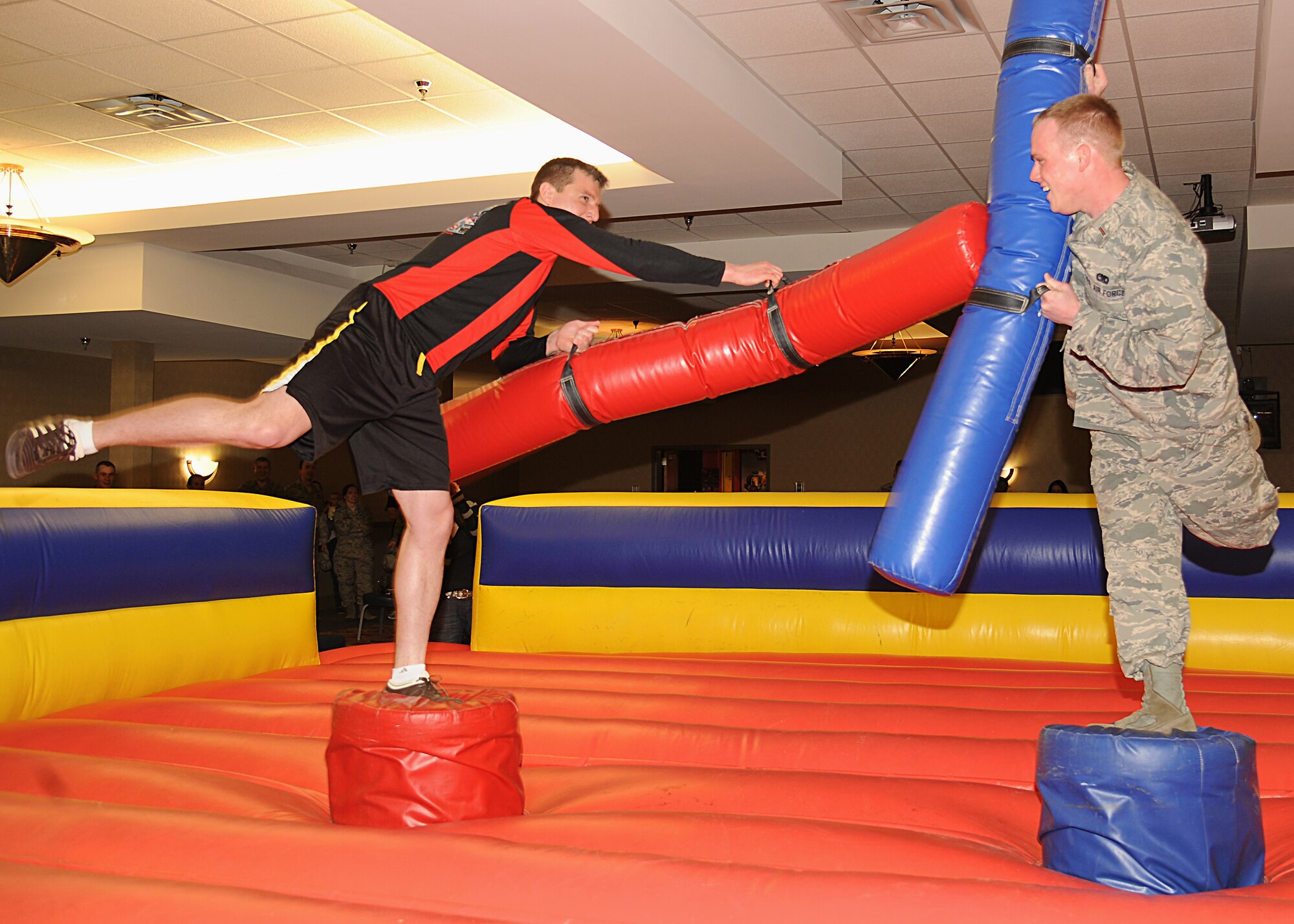 Capt. Paul Knoedler strikes at 2nd Lt. Grant Ellis during a sudden-death round of the Ultimate Pugil Challenge on May 21, 2013, at the Northern Lights Club on Grand Forks Air Force Base, N.D. The event was hosted by the 319th Force Support Squadron. The 69th Reconnaissance Group was awarded the “Top Unit” Trophy, for having the most winners out of the winner’s bracket. (U.S. Air Force photo/Airman 1st Class Xavier Navarro)