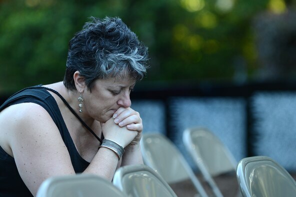 An attendee of the Vietnam Traveling Memorial Wall dedication ceremony, sits alone, solemnly reflecting on its significance, Sumter S.C., May 24, 2013. The traveling memorial wall is a three-fifths scale replica of the Vietnam Memorial in Washington, D.C. The wall stands as a reminder of the great sacrifices made during the Vietnam War. (U.S. Air Force photo by Airman 1st Class Daniel Blackwell/Released)