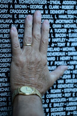 Ronnie Moore, retired U.S. Marine Corps sergeant, touches the Vietnam Traveling Memorial Wall as he prays for those who lost their lives during the Vietnam War, Sumter S.C., May 24, 2013. The traveling memorial wall is a three-fifths scale replica of the Vietnam Memorial in Washington, D.C. The wall stands as a reminder of the great sacrifices made during the Vietnam War. (U.S. Air Force photo by Airman 1st Class Daniel Blackwell/Released)