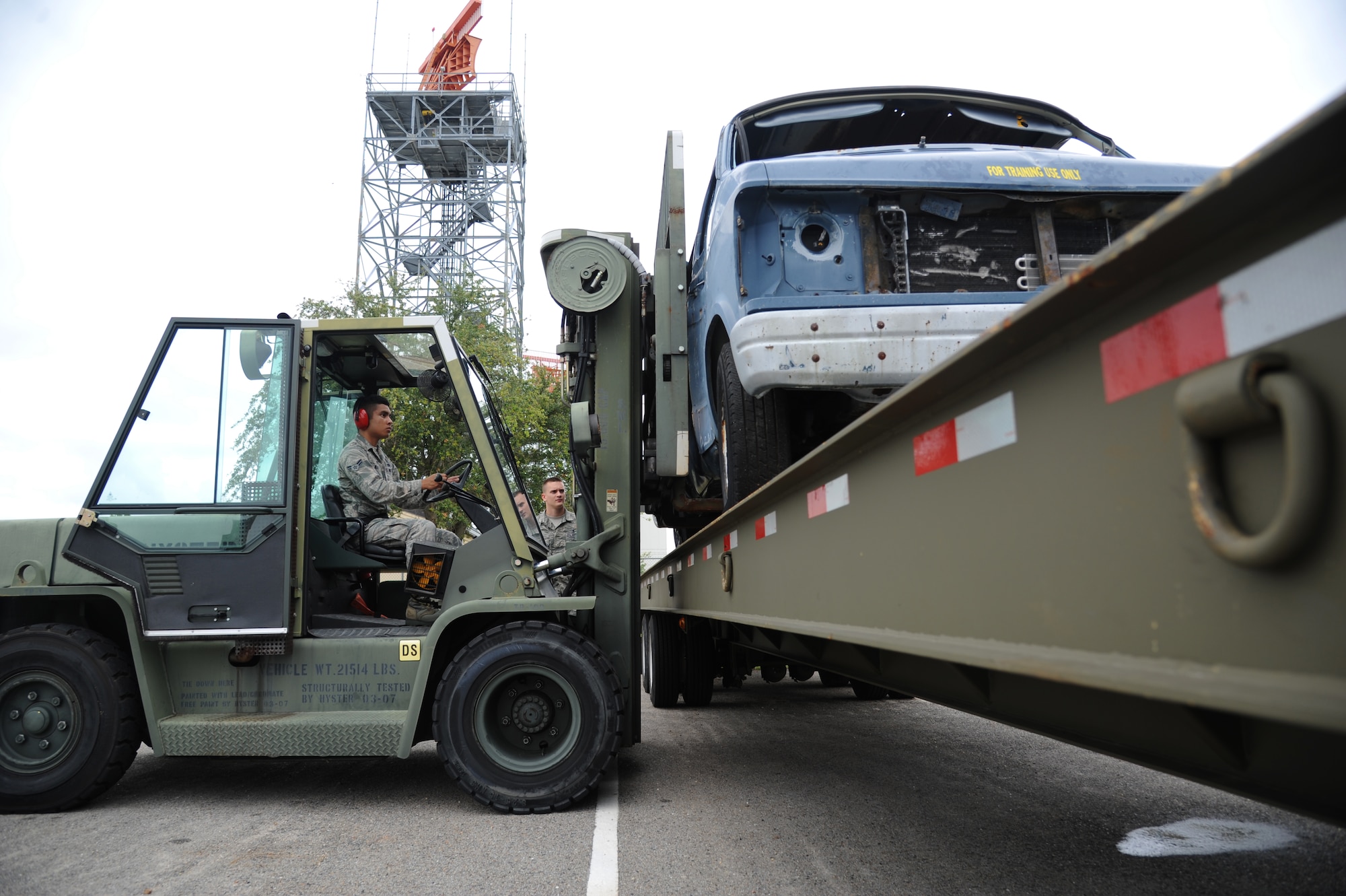 Airman 1st Class Daniel Blas, 81st Logistics Readiness Squadron, operates a forklift to move a van onto the bed of a flatbed truck May 23, 2013, at vehicle operations, Keesler Air Force Base, Miss.  Vehicle Operations duties include transporting vehicles wherever necessary.  (U.S. Air Force photo by Kemberly Groue)