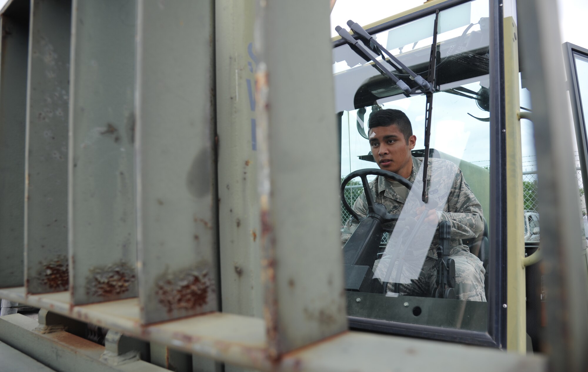 Airman 1st Class Daniel Blas, 81st Logistics Readiness Squadron, prepares to operate a forklift May 23, 2013, at vehicle operations, Keesler Air Force Base, Miss.  One of the flight’s duties is transporting vehicles wherever necessary.  (U.S. Air Force photo by Kemberly Groue)