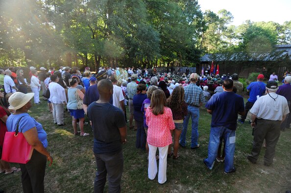 Attendees at the Traveling Vietnam Memorial Wall listen to guest speakers from Shaw Air Force Base, S.C., and the surrounding Sumter community during the dedication ceremony at Swan Lake Iris Gardens, May 24, 2013. The traveling memorial wall is a three-fifths scale replica of the Vietnam Memorial in Washington, D.C. The wall stands as a reminder of the great sacrifices made during the Vietnam War. (U.S. Air Force photo by Airman 1st Class Daniel Blackwell/Released)
